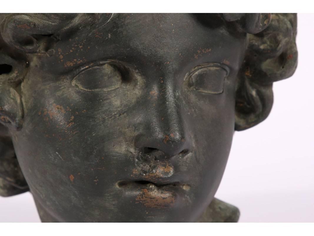 Possibly Italian. Head of a youth with curly hair, turned at an angle. Probably an angel as part of a larger sculptural group. With patina and incrustations.
Condition: nice age related patina, some holes around the face, nose and mouth.