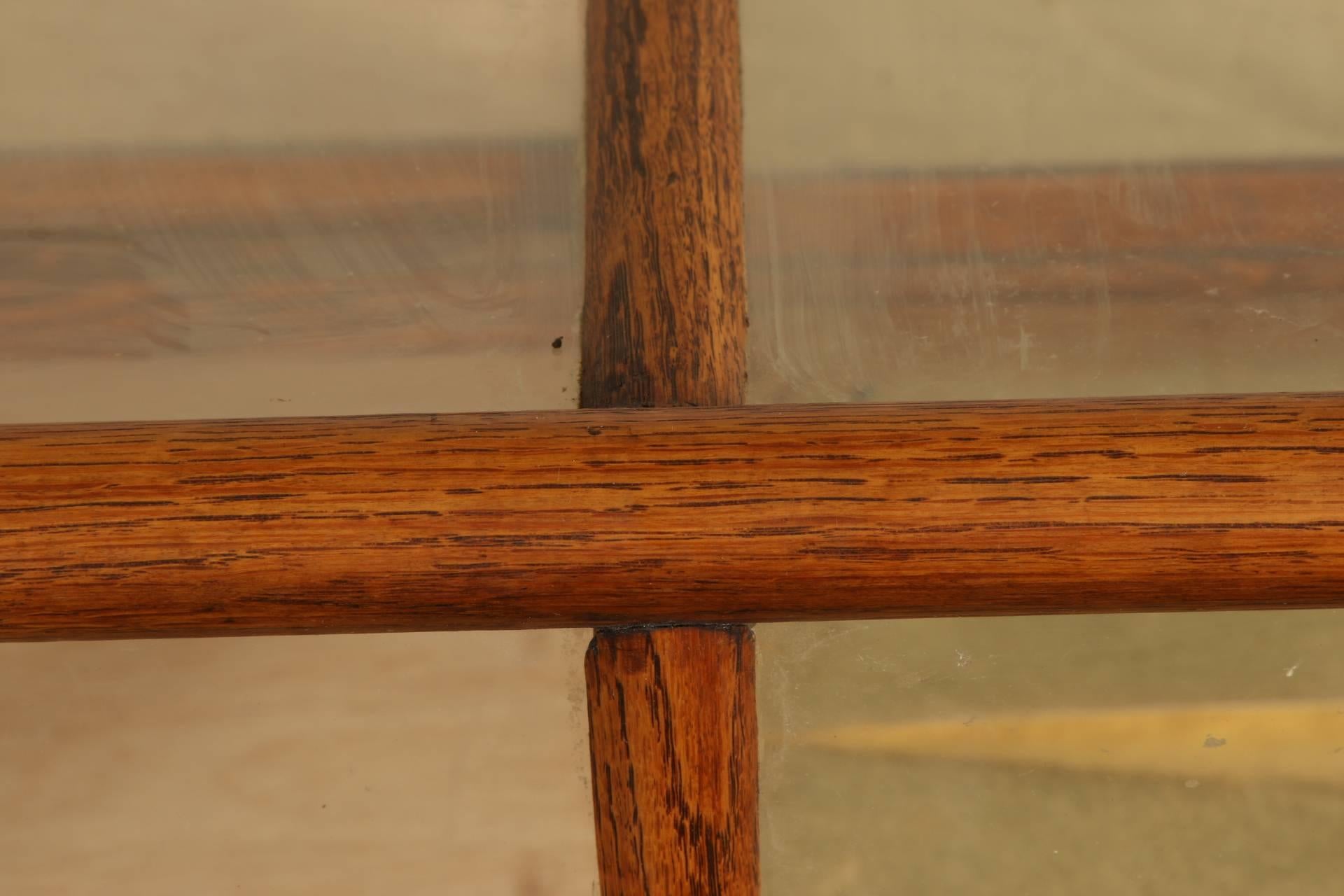 Oak with divided glass, and two sliding rear mirrored doors. Appears to be in original finish. Gilt foil lined.
Dimensions are taken at the bottom molding.
Condition: A few scratches to the wood.