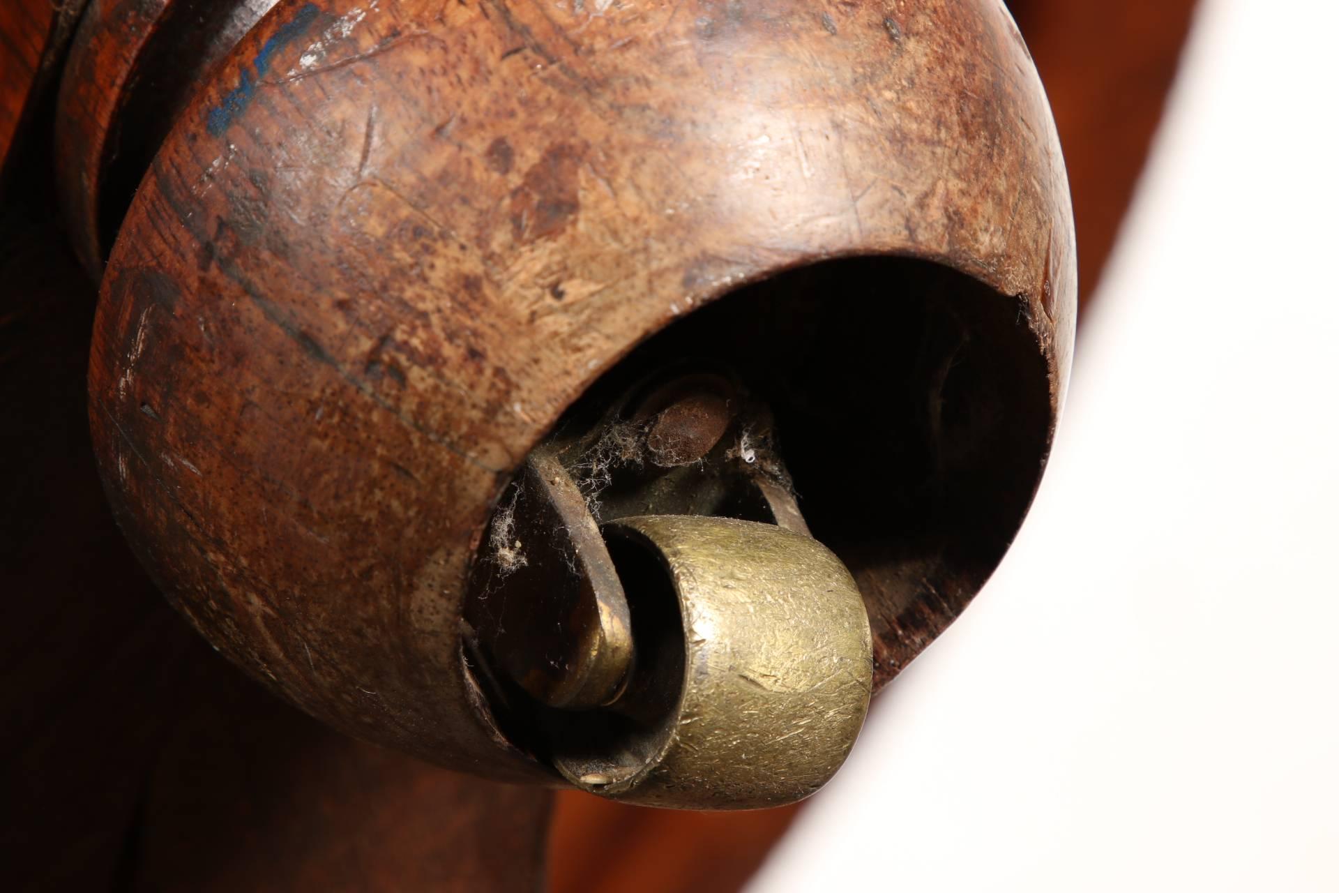 Rosewood tilt-top center table with massive turned columnar pedestal over a tripod base raised up on turnip feet. The top is heavily carved with gadrooned and twisted bands.
Condition: good.