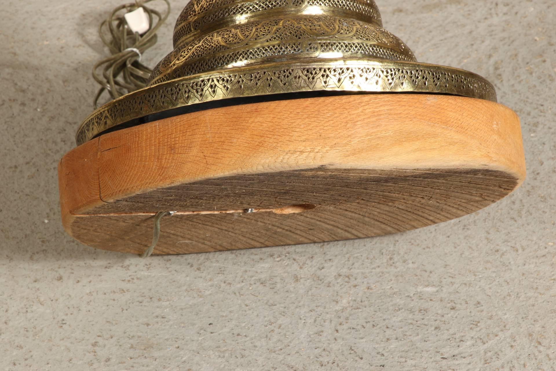 A pierced brass standard with flared top and tiered bulbous base. With brass top lamp fittings and mounted on a circular wood base.
Condition: some wear to the wood base.