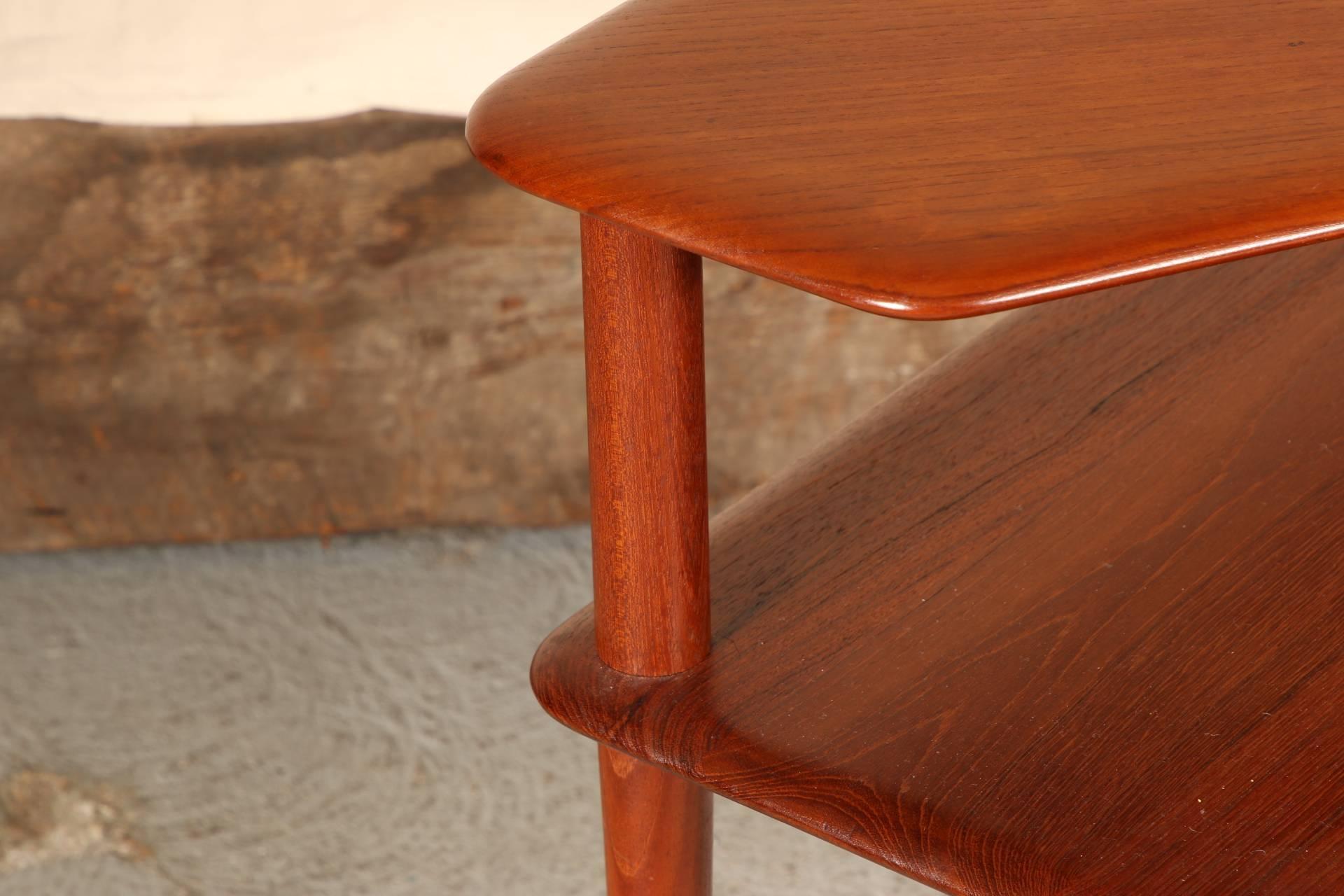 A wonderful Danish two-tier table with boomerang top, tapering legs, smooth waterfall edge. Hallmarked under top tier as shown. Designed by Peter Hvidt and Orla Mølgaard Nielsen for France and Son of Denmark, circa 1957.
Condition: some faint water