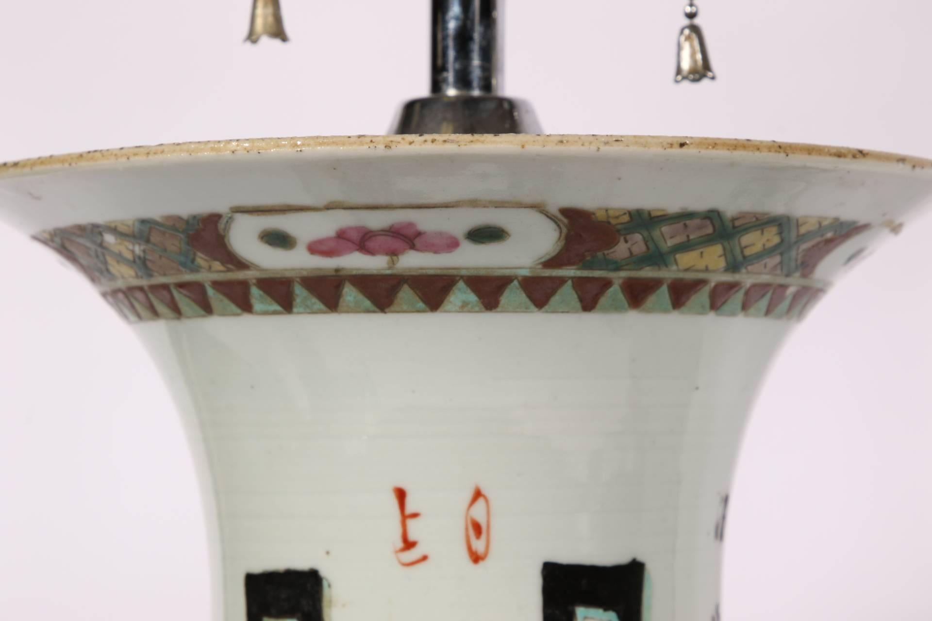 White flared forms with polychrome decoration depicting footed vessels on front and back and inscriptions on the sides. Decorative rim and base bands. Mounted on wooden bases. Chrome fittings. Vase height is 15.75 inches.