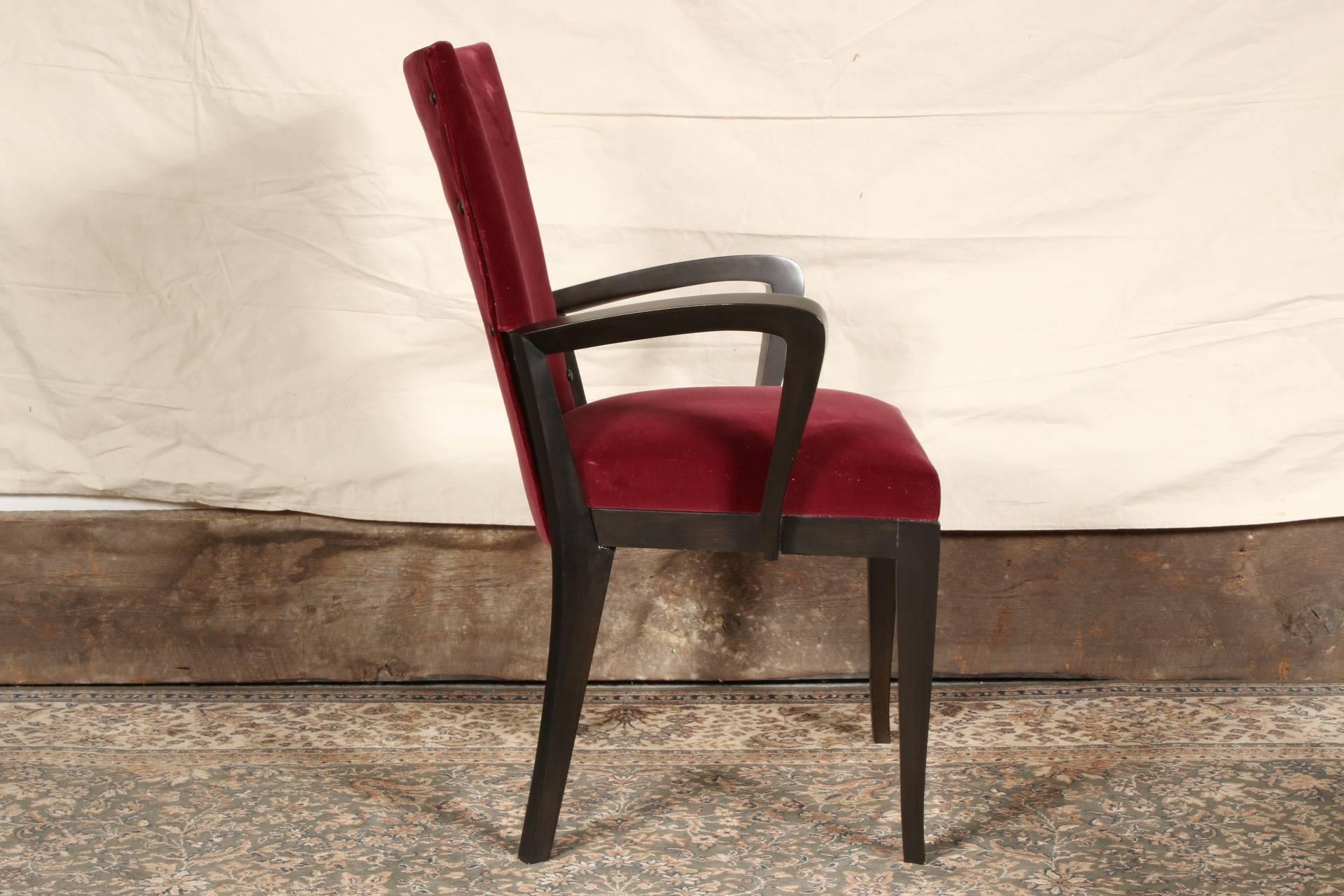 Fine dark wood frames with shaped arms and tapering square front and splayed back legs. Slightly shaped backs upholstered in wine colored velveteen with black leather buttons on the fronts and backs.
Condition: slight wear to the tops of the backs.