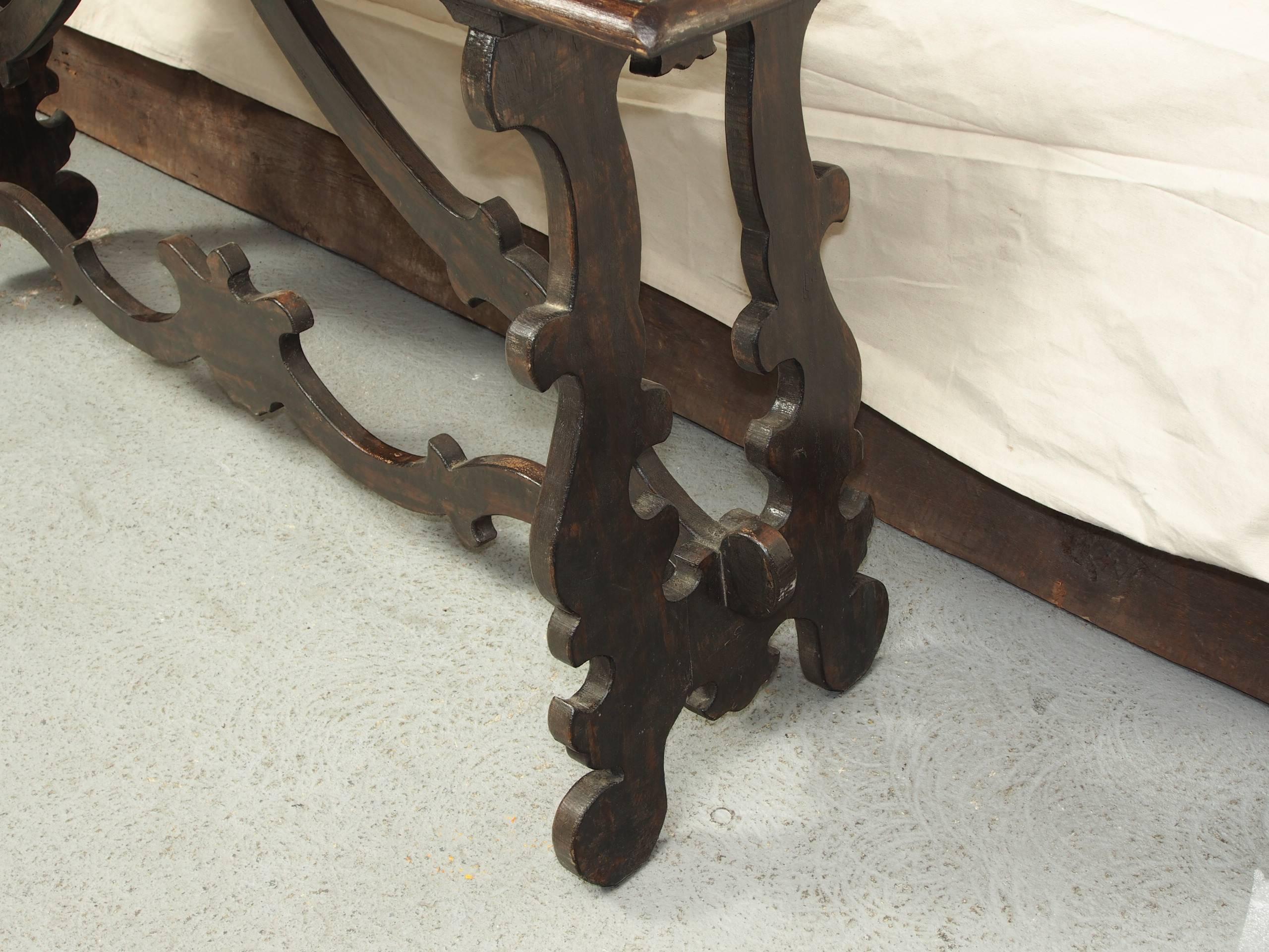 Console table with planked top, ornately scrolled stretcher.
Condition: few faint scratches, consistent with age.