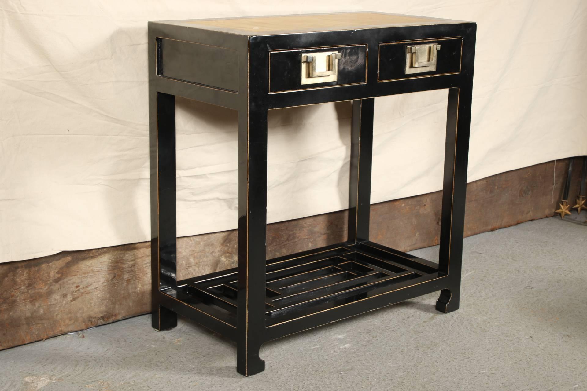 From ABC Carpet and Home. Rectangular with two apron drawers with squared brass handle pulls and an inset bamboo panel on top. The sides and back with recessed panels. The base with a large geometric design openwork stretcher.
Condition: Pale