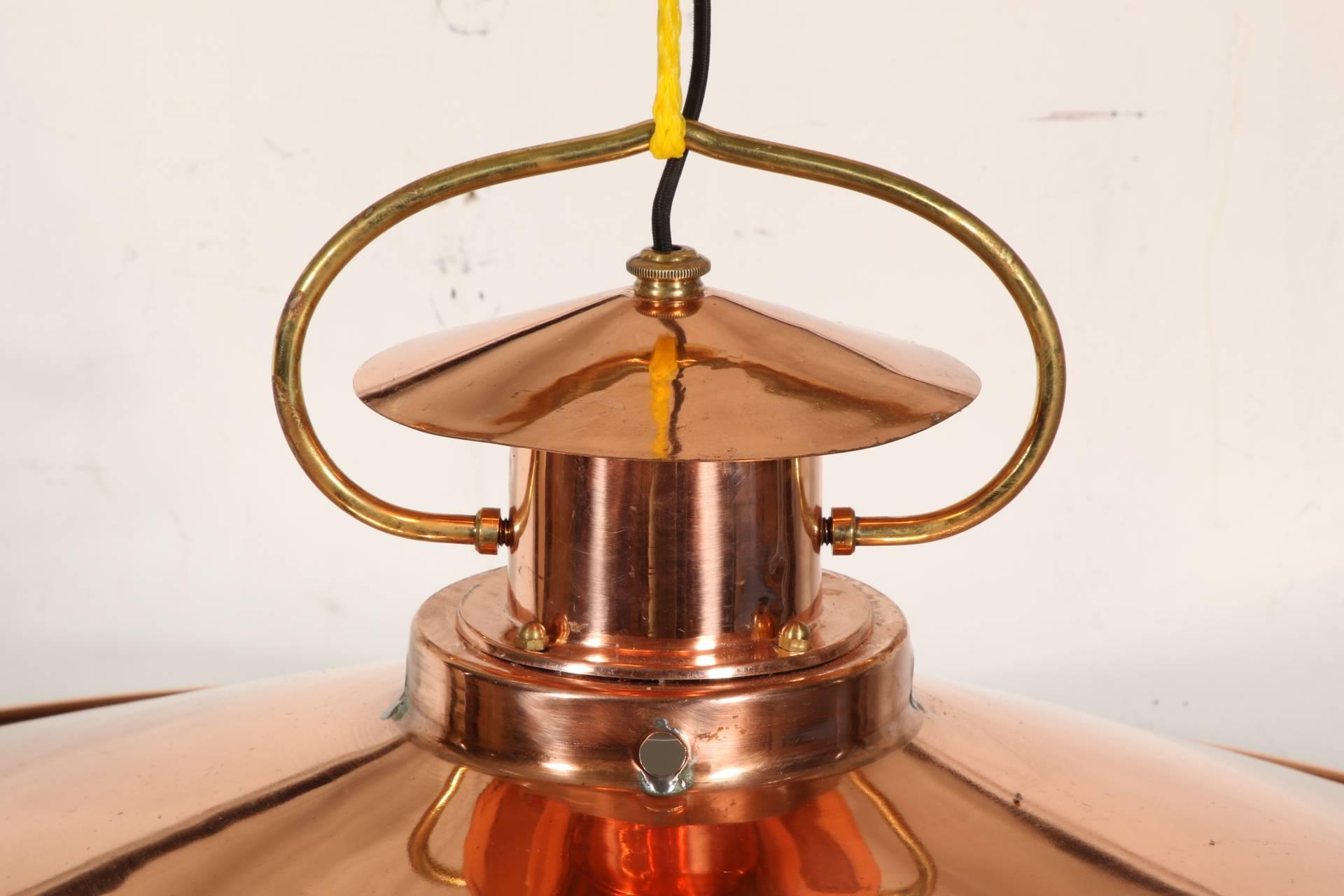 Single light copper disk with a lantern form top and a brass top suspension attachment.
Condition: some losses to finish and holes around the lantern base.