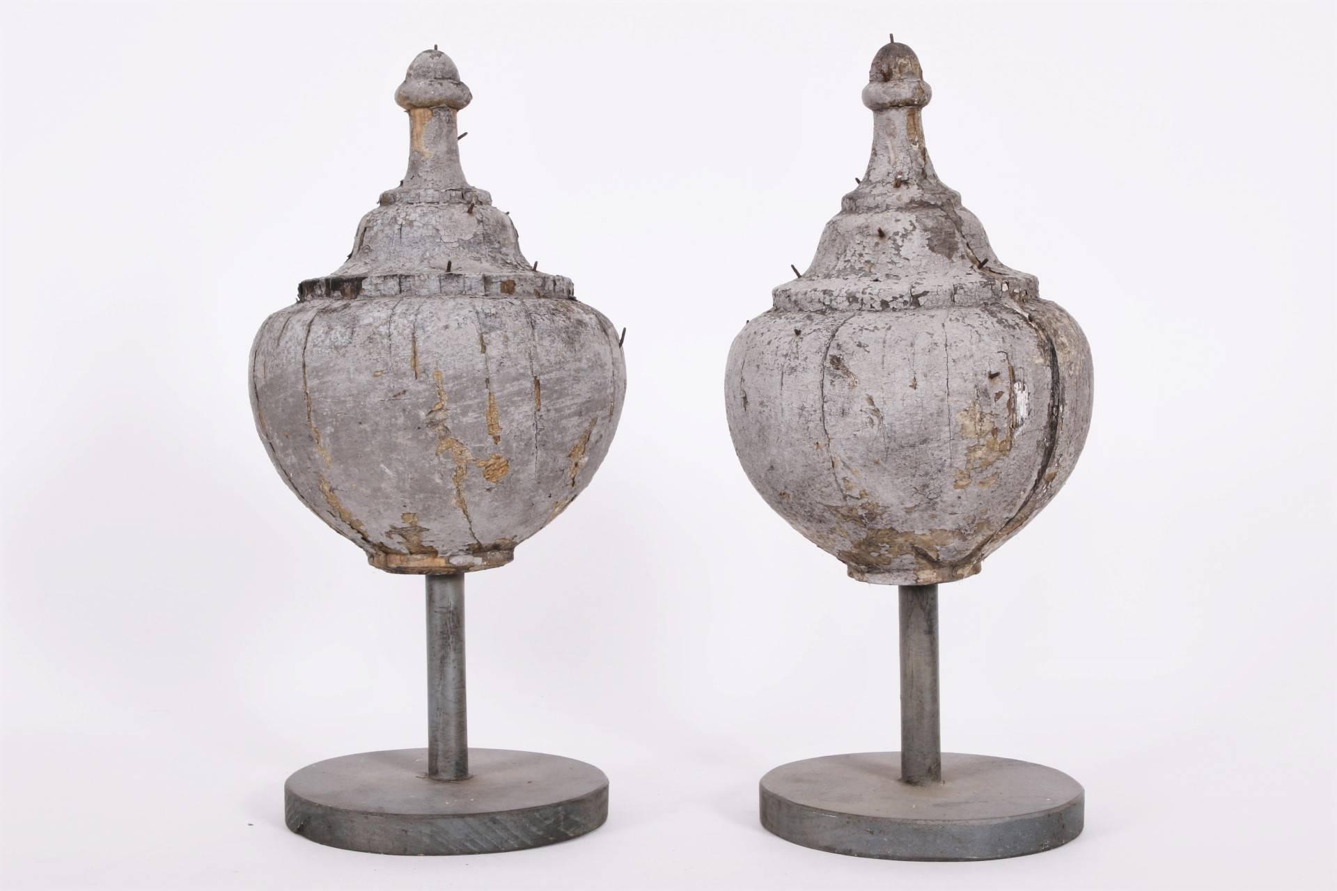 In a weathered grey paint. Mounted on stands.
Condition: cracks through the centres, overall weathered paint.