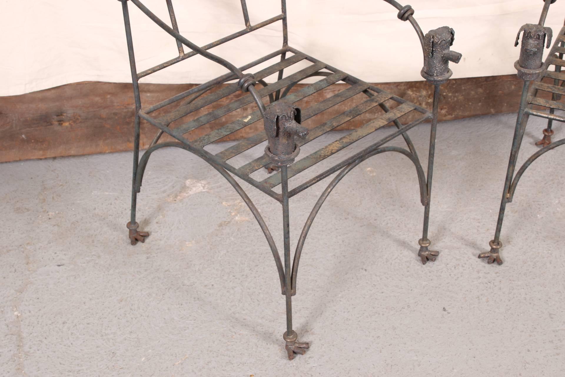 Heavy construction wrought iron with a golden patina, slatted seats, crest rails with a circle, and arm ends in the form of canine heads. The legs with curved stretchers on all sides and ending in bird feet.
Measures: Seat height is 17.25 inches.