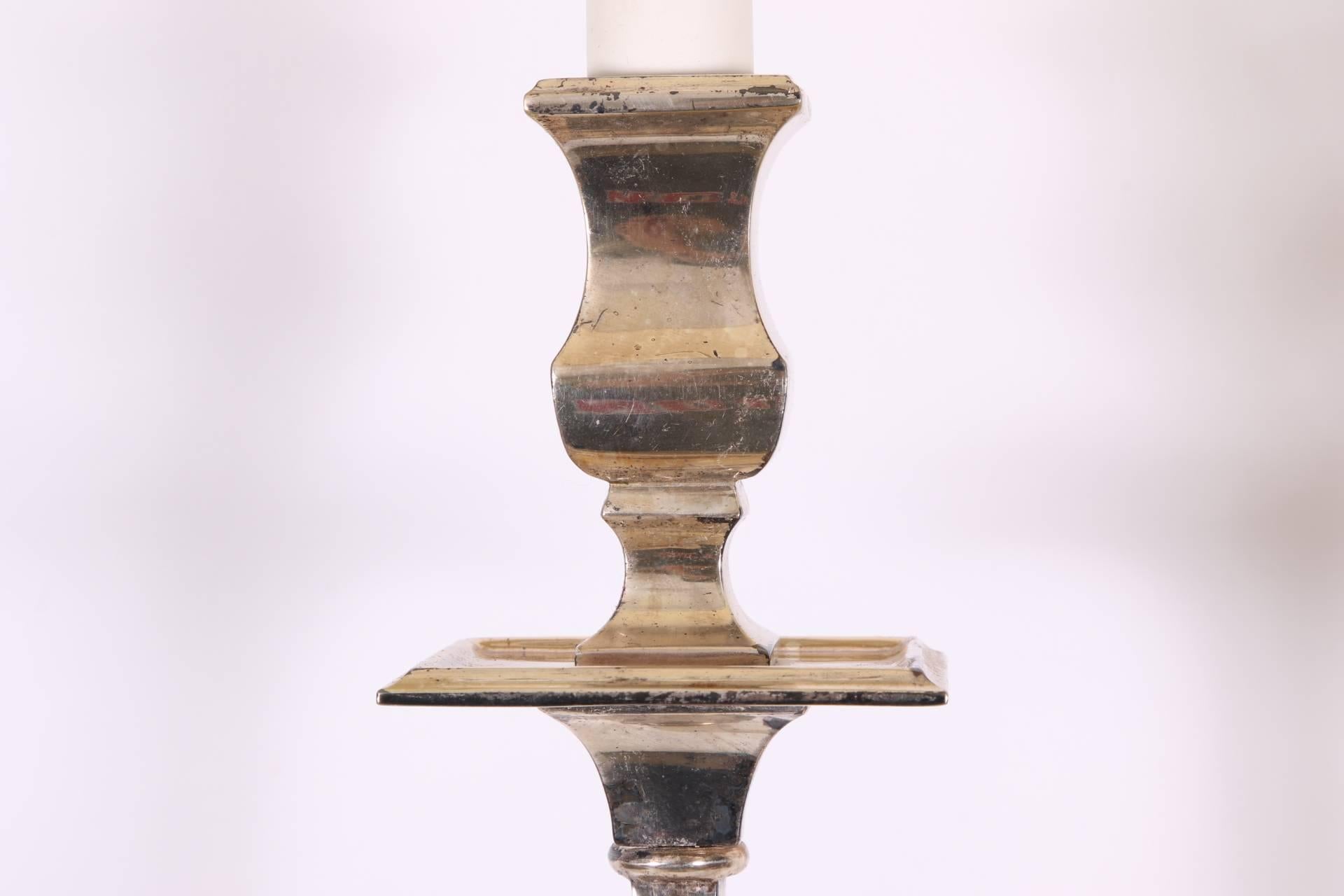 Each with double lights with urn form sockets and bobeches. The tall shaped supports are attached to terminals with star motifs in relief, with rectangular shades. Nice patina with wear to the silvered finish. Depth of fixture alone is 5 inches.