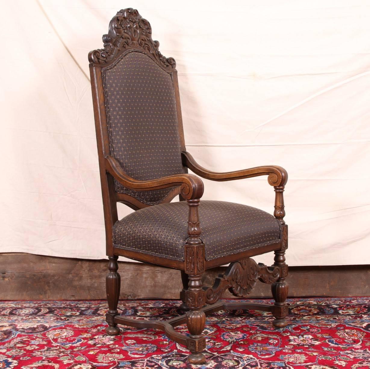 With a tall crest rail with foliate scrolls and scrolled arm ends with acanthus bases. The lower front stretcher with carved shell and acanthus leaves. Raised on three-part turned legs on bun feet, with a shaped H stretcher. In a dark grey and brown