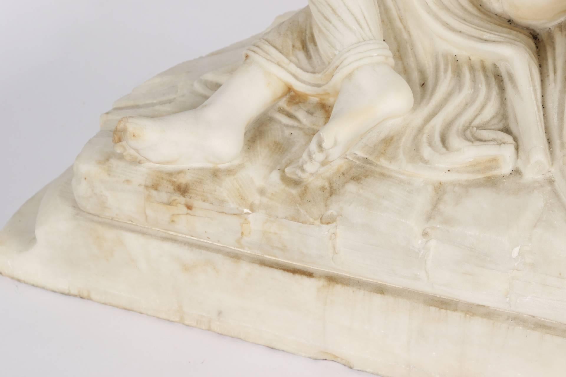 A female semi-nude figure with long flowing hair reclining on a drapery covered demilune base, with a nude male figure standing over her in an embrace. Mounted on a demilune grey and white marble base. The male figure with two notches on is upper