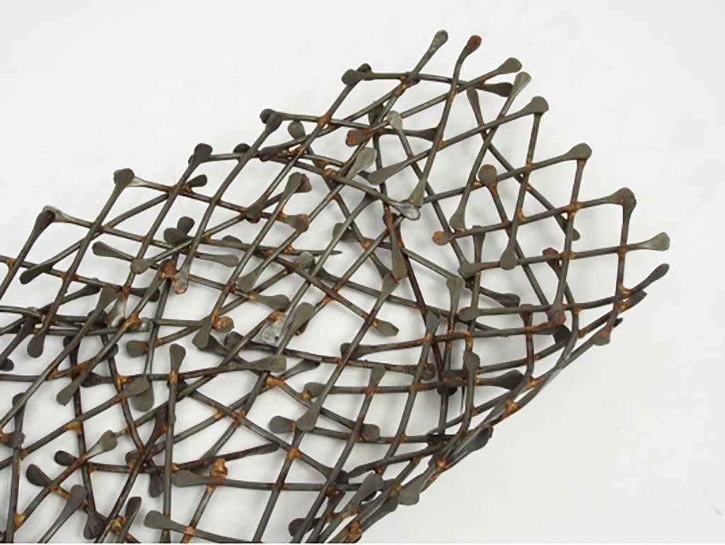 Created from a myriad of paddle form metal tines. Can be used as a wall sculpture or a bowl.