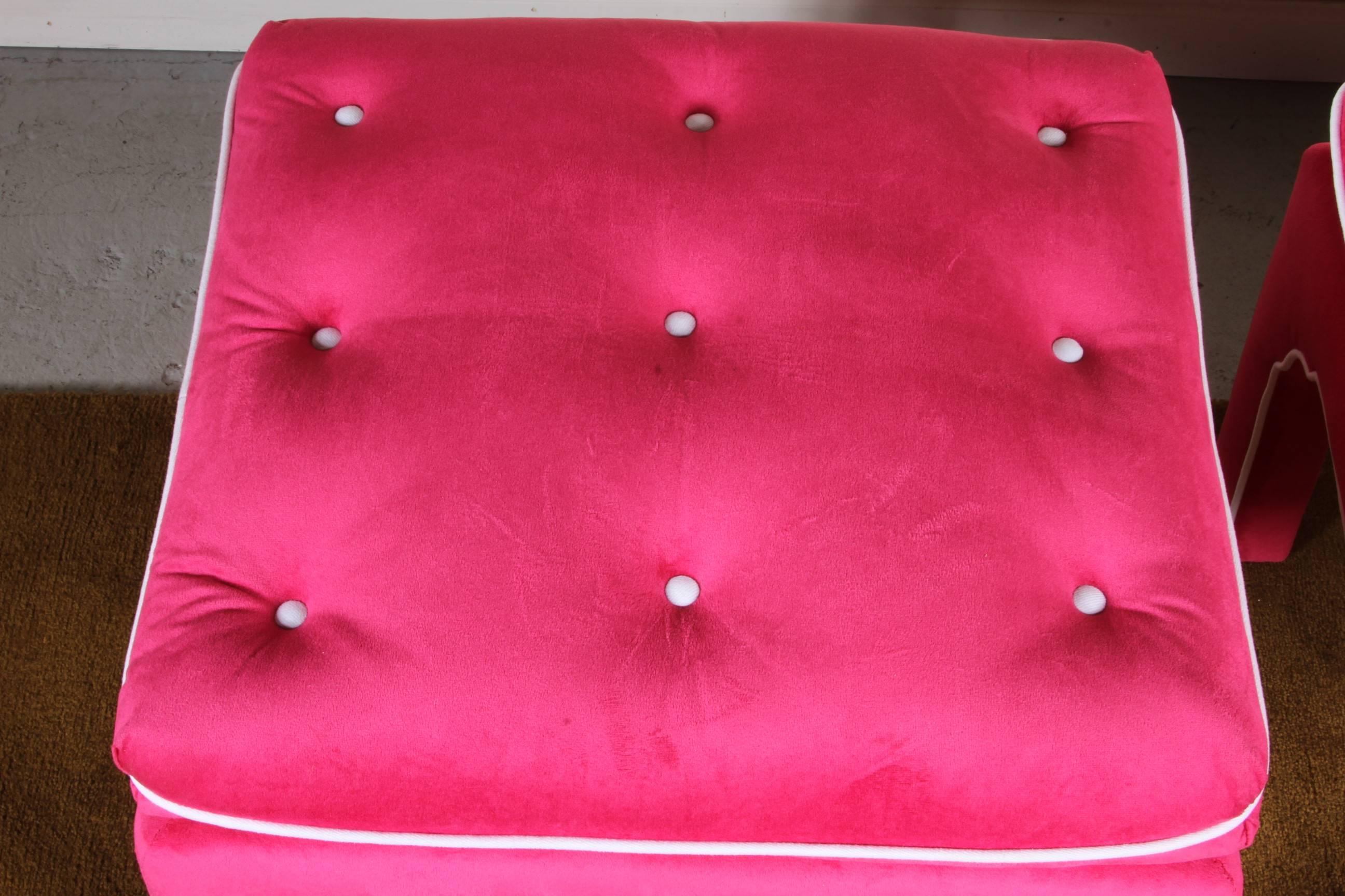 Outstanding pair of footstool/ottomans with very good proportions and fine tailored custom upholstery. Vibrant hot pink cotton velvet with white duck trim and buttons. In overall excellent condition. Measurements given are for one ottoman.