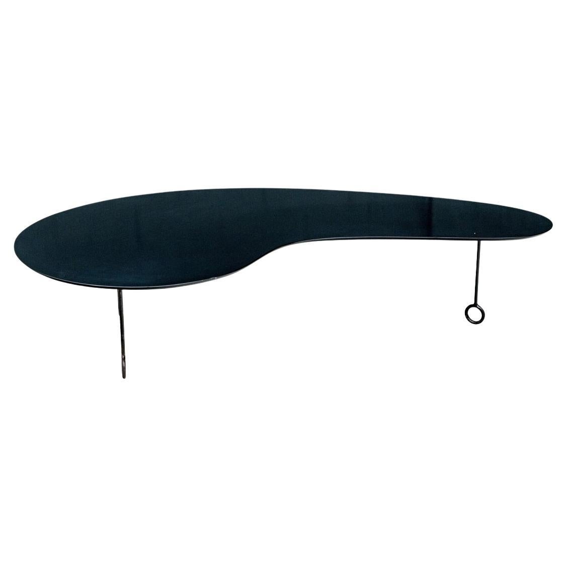 Un design incroyable et très moderne d'après Jean Royère. Cette table finement travaillée est conforme au modèle original datant d'environ 1957. Elle est fabriquée en bois stratifié noir en forme de boomerang et repose sur trois pieds en métal noir