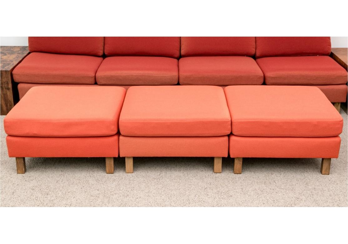 Being sold as a restoration project. Set of three custom Mid Century Modular upholstered ottomans with removable seat cushions with zippers and raised up on square legs. In its original upholstery original to the home built in 1975. Some remnant