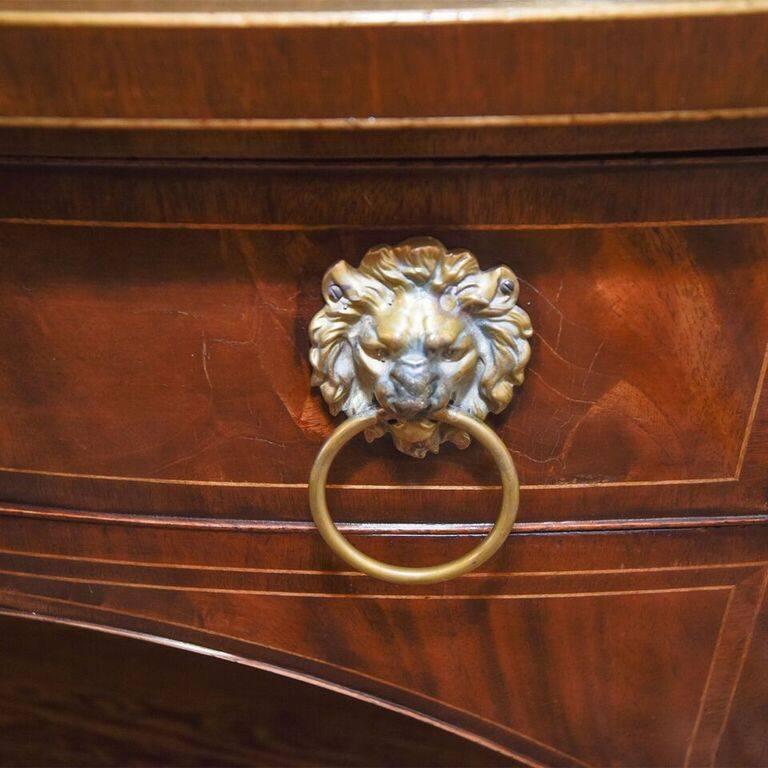 In the style of an antique George III piece with lion head brass pulls with beautiful antique finish.