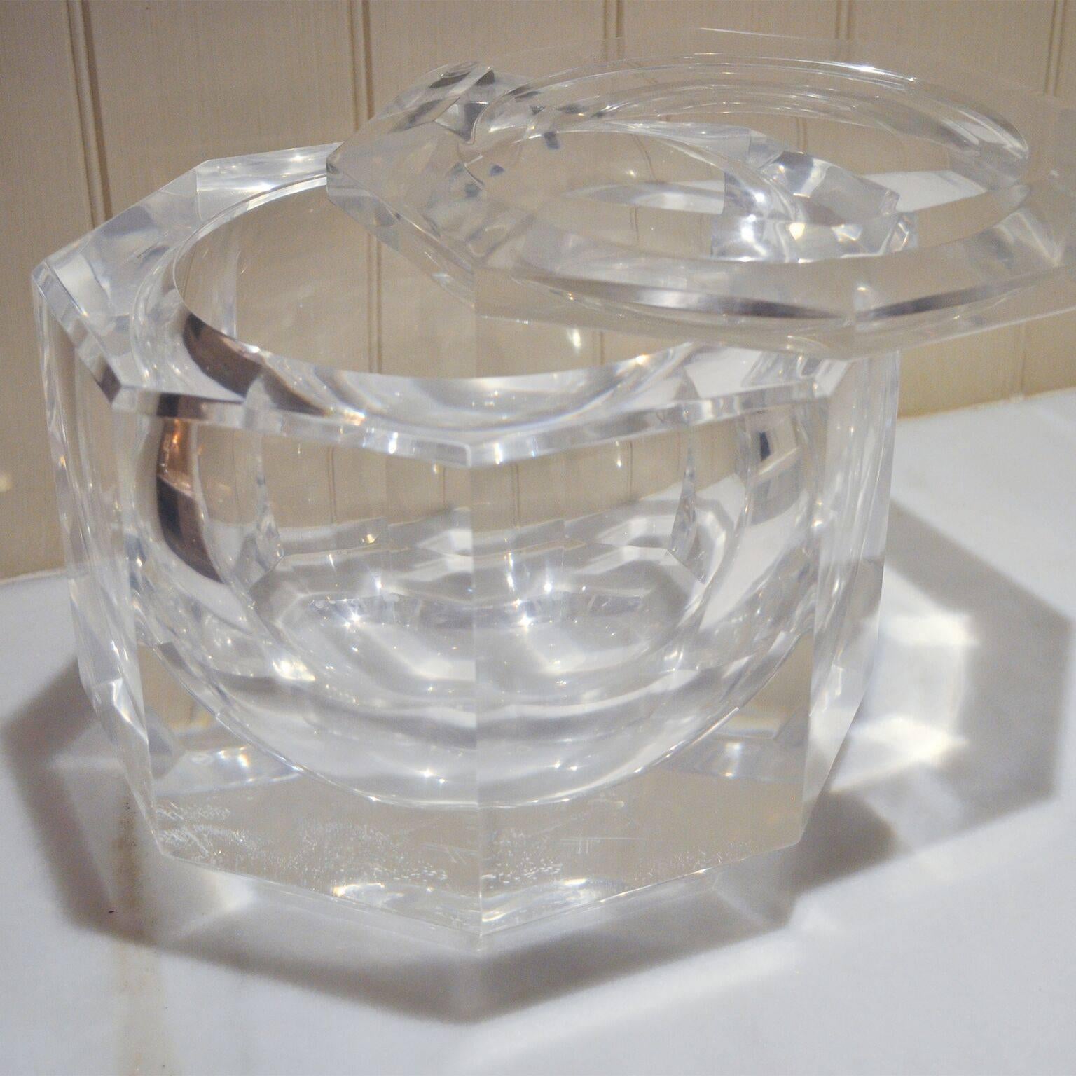 In the style of Carole Stupell, this Lucite ice bucket has a faceted base with swivel Lucite top. 
Condition: Good, has some scratching consistent with age and use.