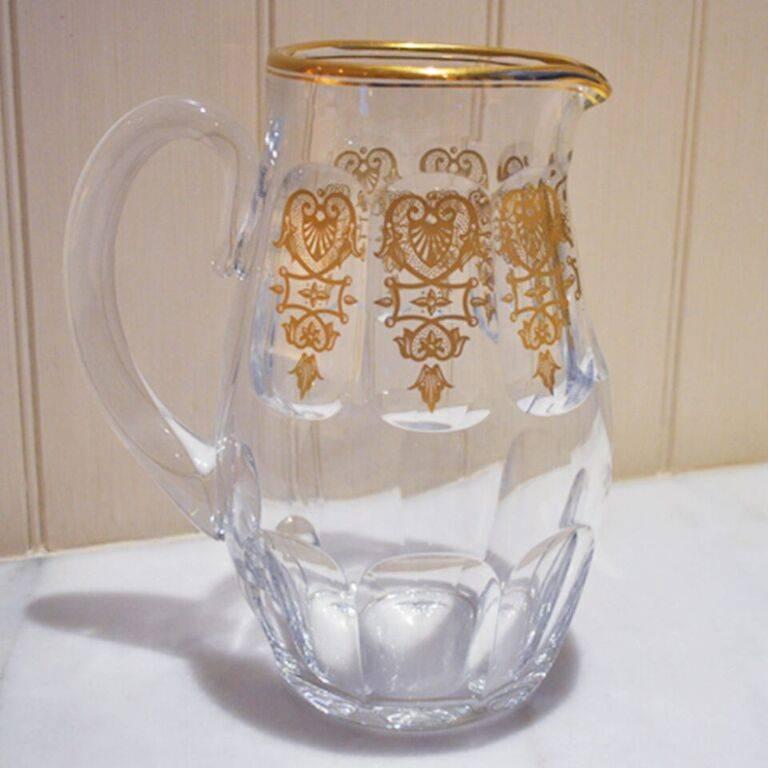 This elegant crystal pitcher by Baccarat has the discontinued Empire pattern which dates to 1825. The pattern has golden damask accents and yellow gold trim.