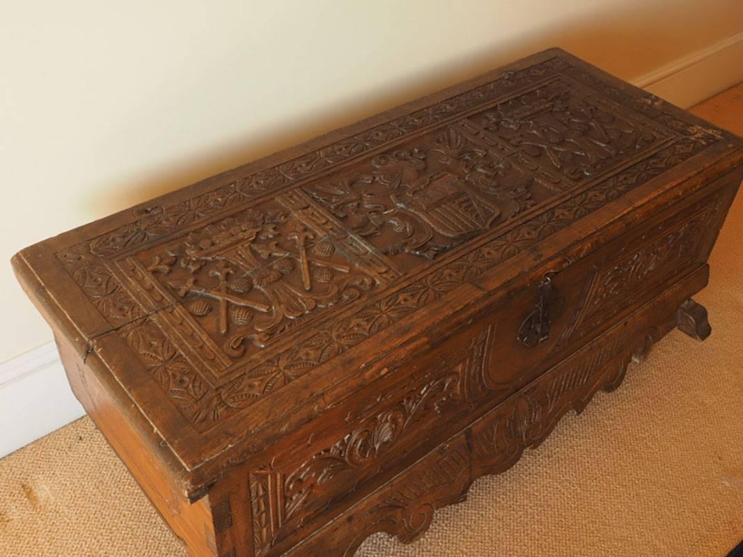Antique carved chest with heraldic images, iron lock, deep relief carving throughout. A great primitive piece.