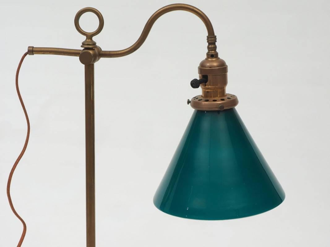 In very good condition with adjustable height, ring finial, twisted brass column base and wrapped champagne silk cord.