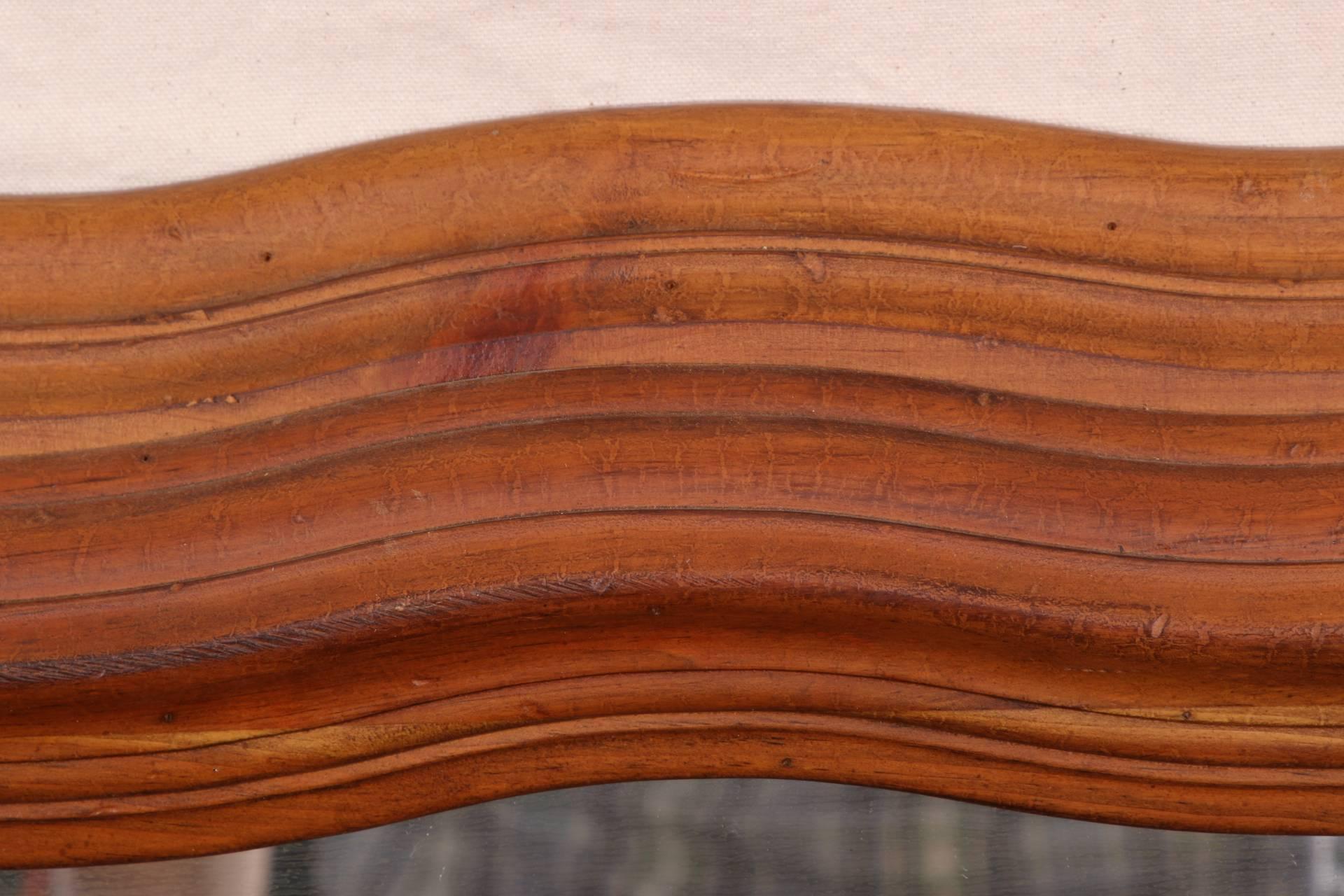 With carved, ribbed and wavy surrounds in a walnut finish. 
Condition: some stains to the wood, otherwise good.