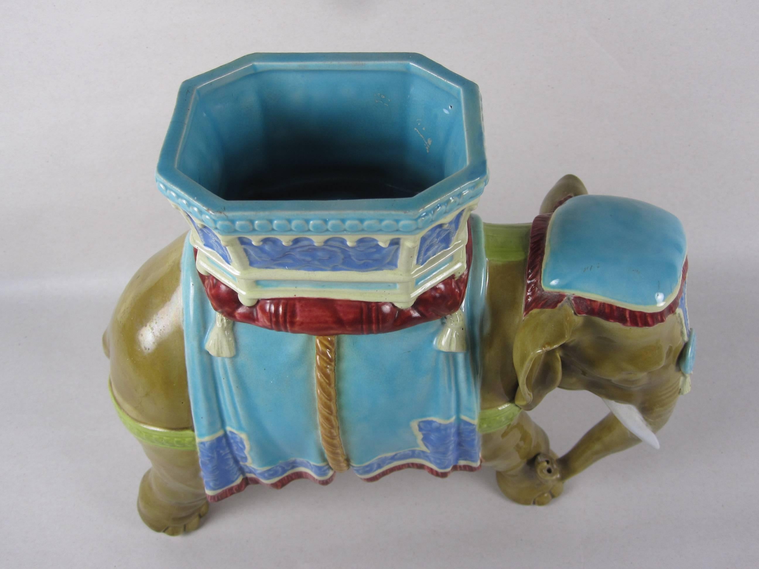 An excellent quality Majolica elephant vase, circa 1865, sculpted by Royal Worcester’s chief modeler, James Hadley, Staffordshire, England. An Indian elephant wearing a ceremonial howdah and head dress. Marked with the R.W. crest and diamond