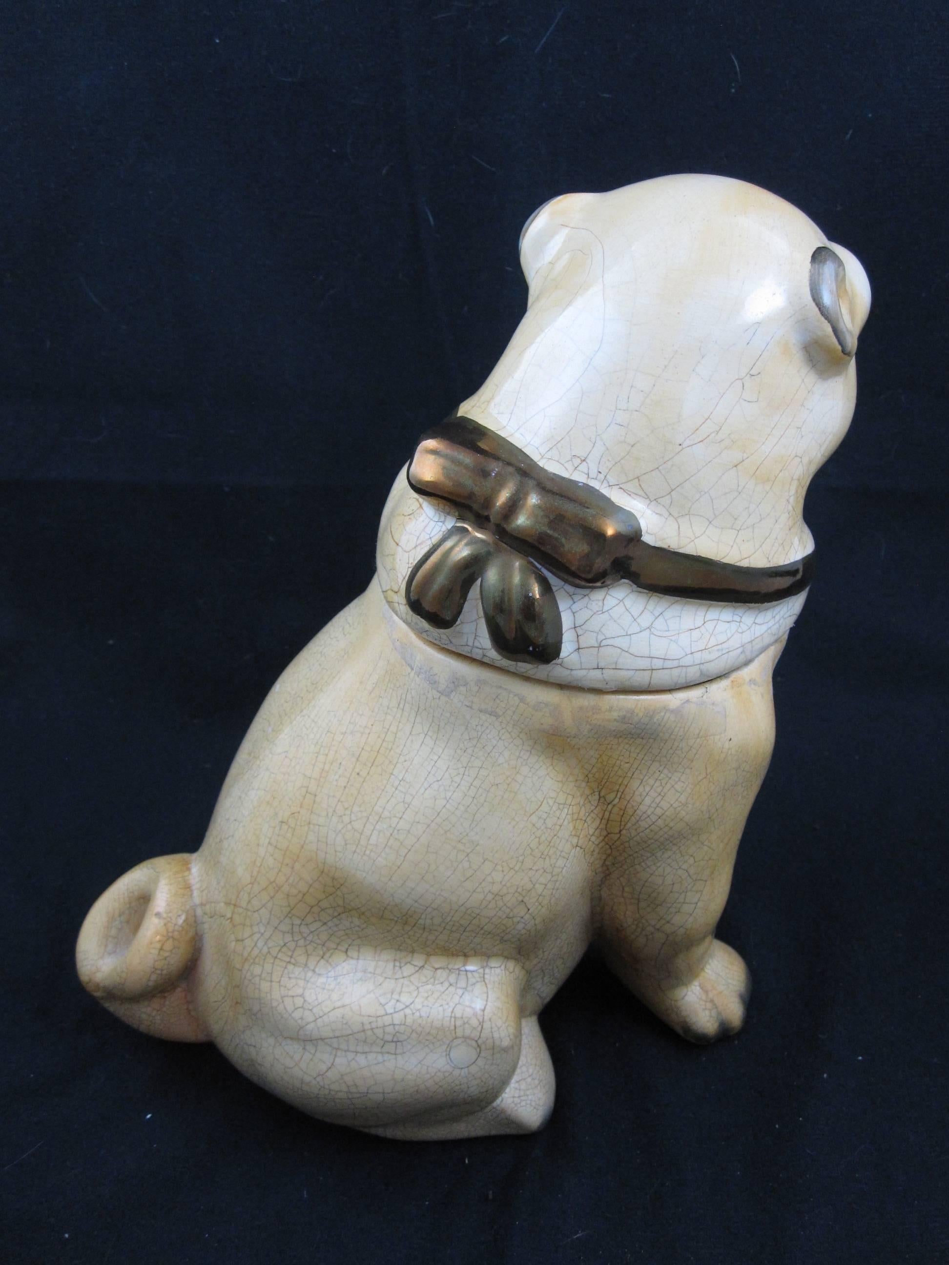 A large English Staffordshire two-piece pug dog jar, circa 1880. This Puggie has a great expression and a posture true to breed. Detailed with a bronze luster ribboned collar tied in a bow to the back, split front legs and a curled tail. He has an