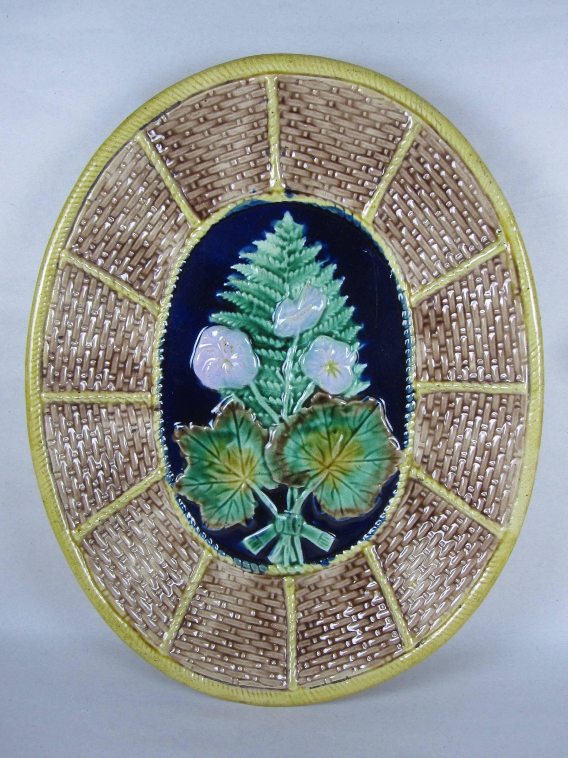 In incredible antique condition, a 19th century English Majolica glazed oval serving platter or cheese board, Adams & Bromley.

Showing a fern and floral pattern on a woven basket ground. The woven wicker motif is commonly seen in platters made for