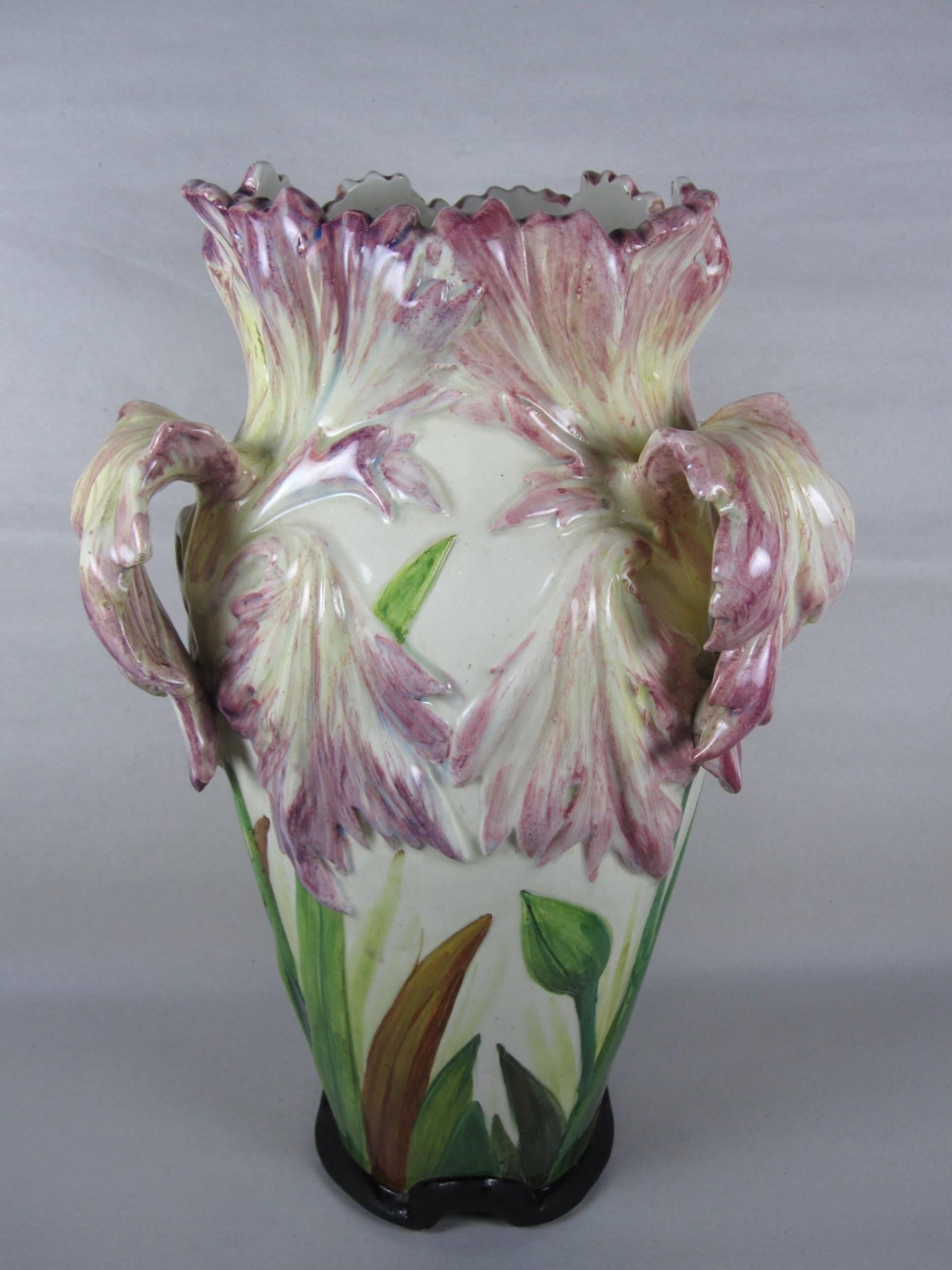 A late 19th century, large French Barbotine, Majolica glazed Art Nouveau pottery vase with a Parrot Tulip theme. Three pink cascading petals make up the handles on a cream colored body with hand-painted foliage and tulip buds encircling the base.
