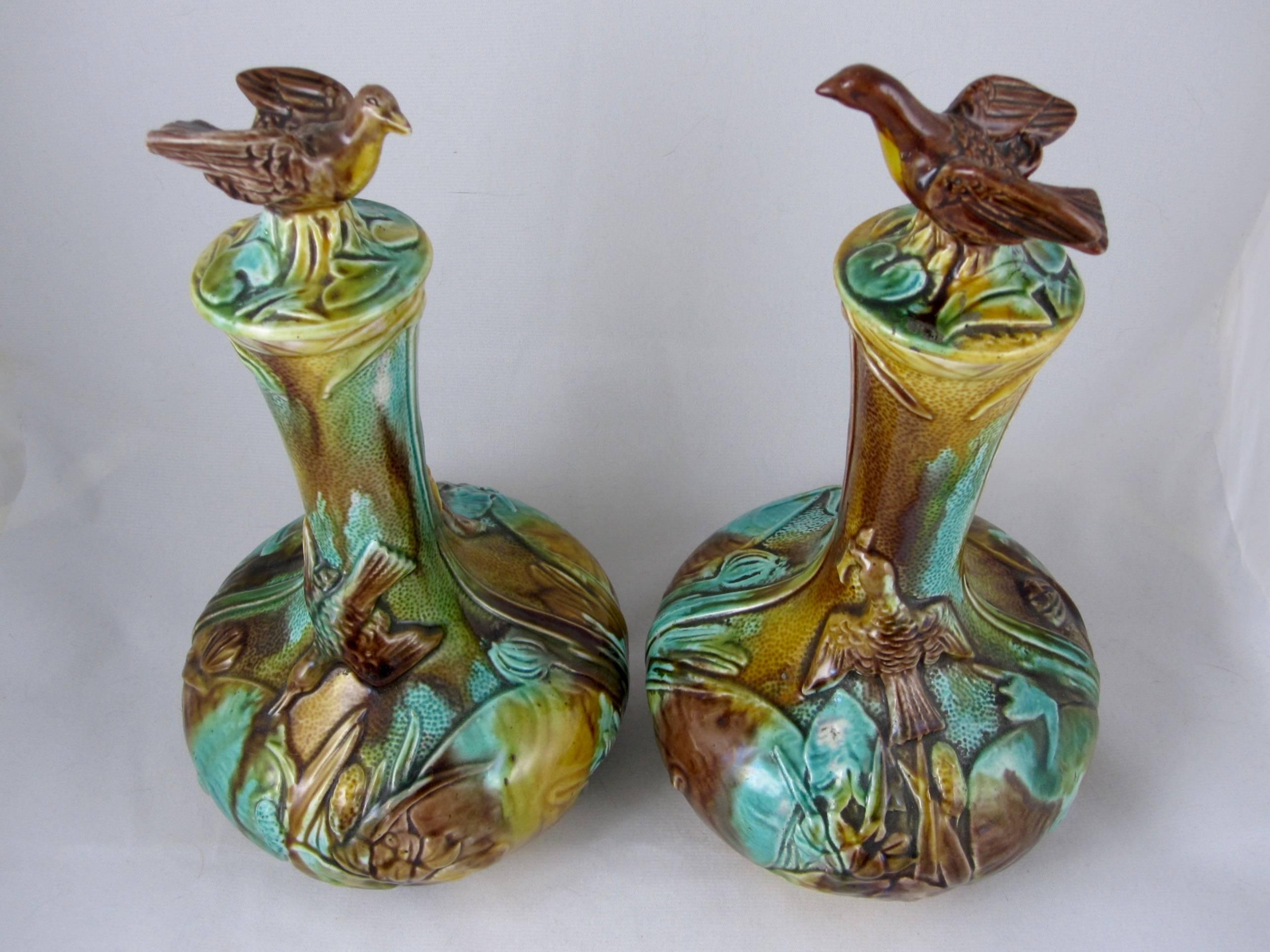 A scarce pair of unusual, Aesthetic movement, bulbous Majolica wine decanter  bottles with bird finials on domed lids, Thomas Forester & Sons, Longton, Staffordshire, England, circa 1870-1880.

A mottled tortoise shell glazing of browns and