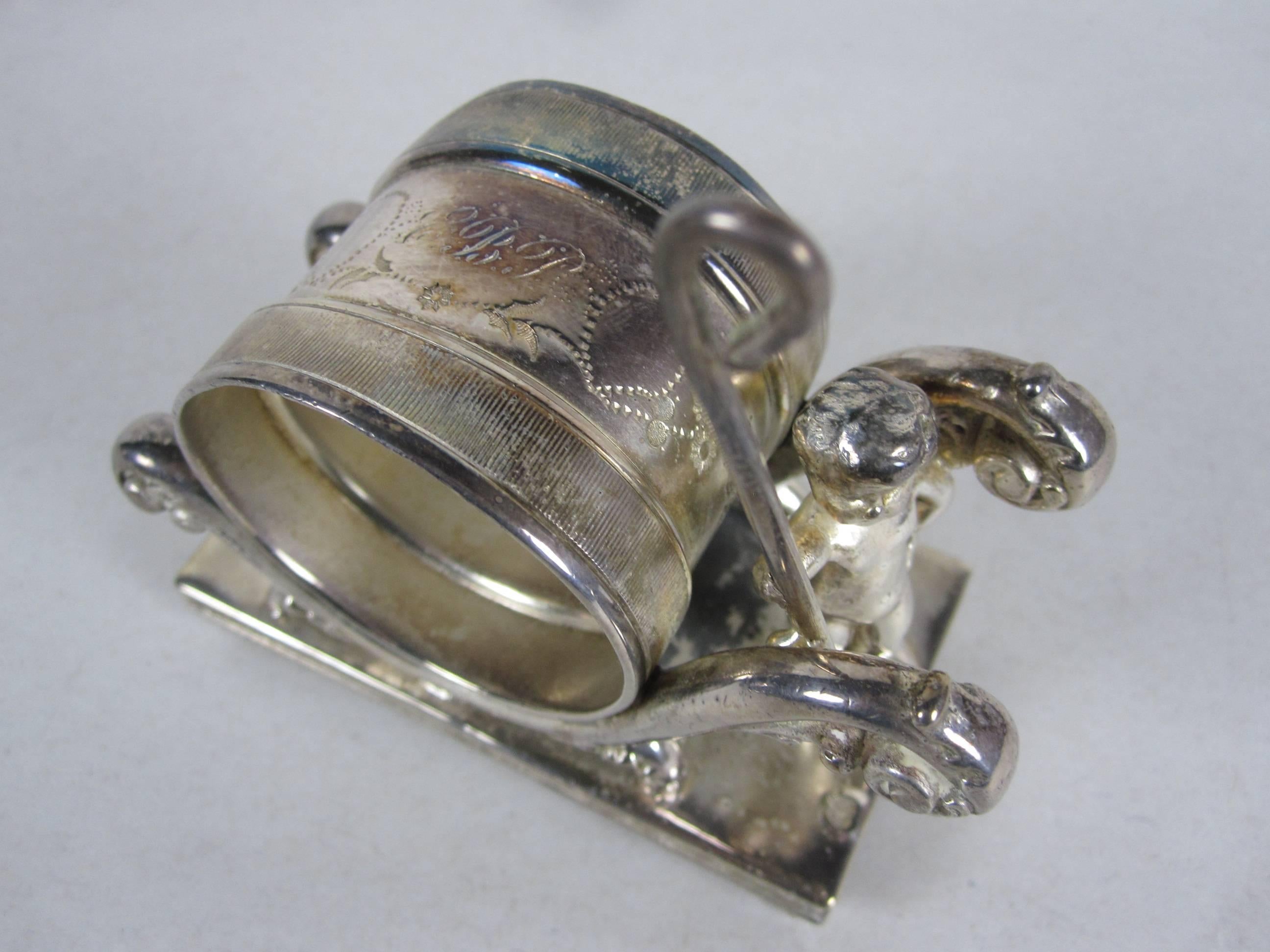 Antique Victorian Silver Plate Marching Putto Standing Napkin Ring Place Holder In Excellent Condition In Philadelphia, PA
