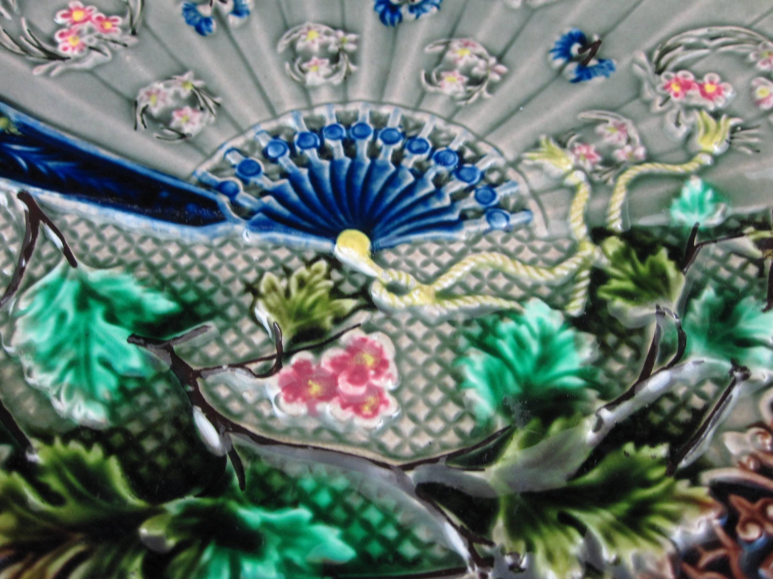 A 19th century, Art Nouveau, Japonisme Majolica pottery wall or cabinet plate. Manufactured by Villeroy & Boch, Germany, circa 1900, in an intricate fan and floral pattern with deep rich color.

A rarer example, this Asian influenced mold shows a