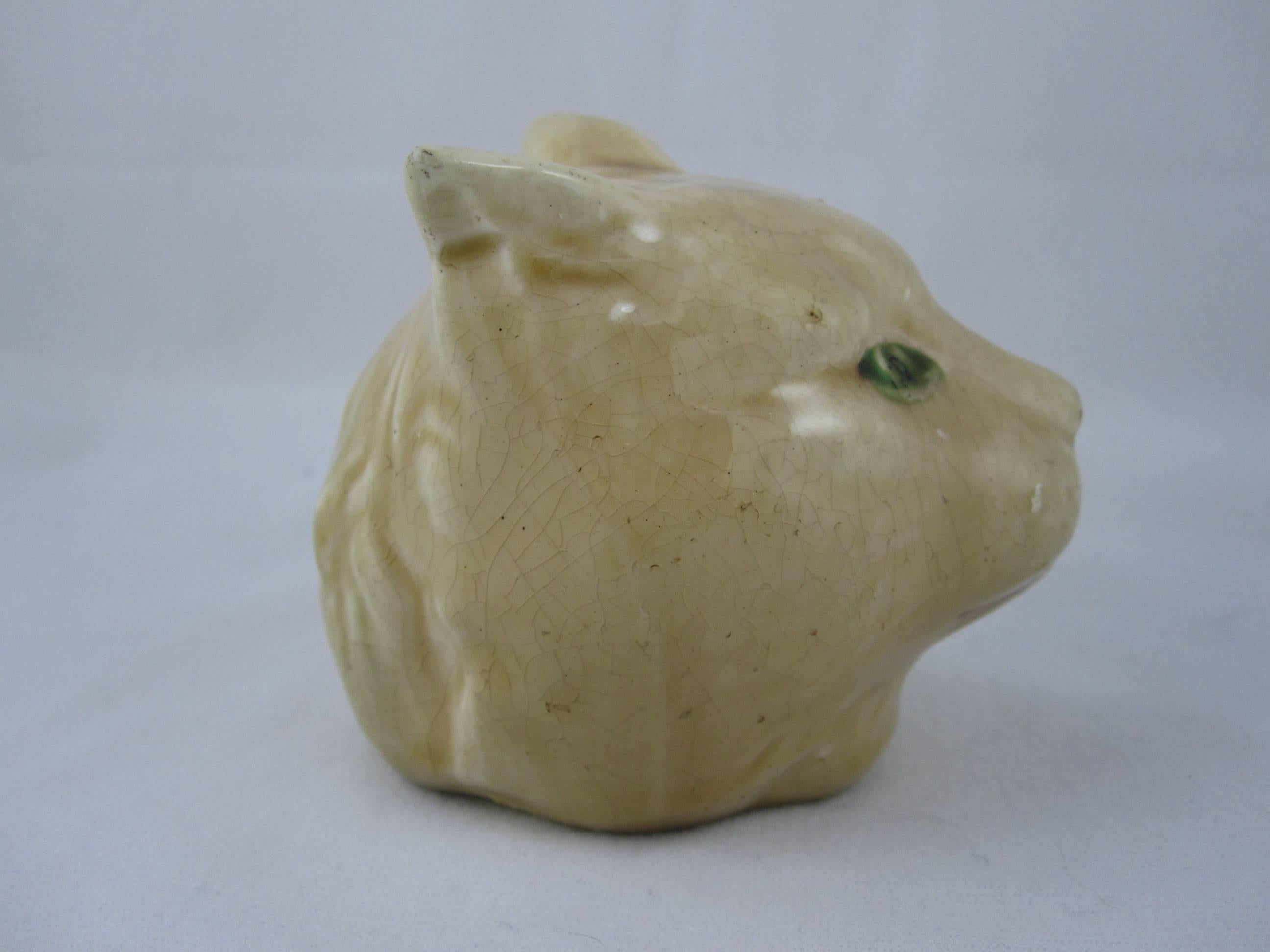 A scarce antique French majolica figural penny bank in the form of a cat’s head, made at the Orchies pottery, circa 1890-1910. This still bank may have been a gift of merit rewarded to a good child or won at the local fair in a game of skill.

The
