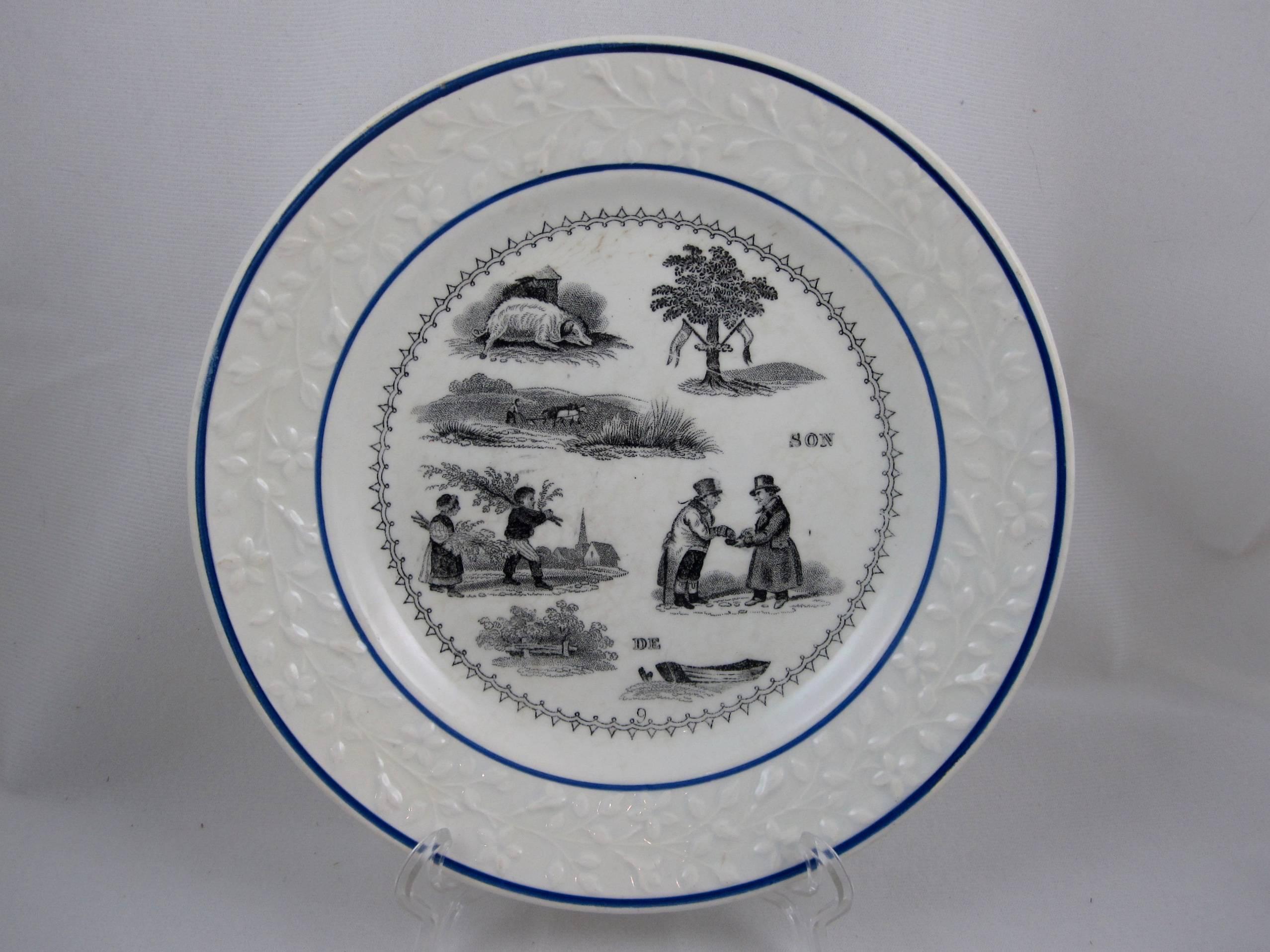A set of six French Rebus puzzle dessert plates, transfer printed in black on a white semi-porcelain body. When solved, the picture puzzle spells out a wise saying or maxim, circa 1841-1876.

From the early 1800s into the early 1900s, most French
