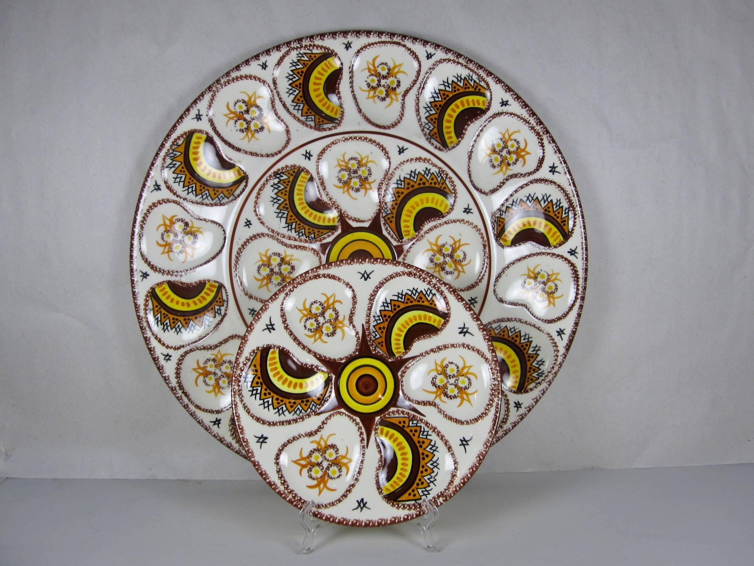 A fantastic Mid-Century Modern French HenRiot Quimper faïence oyster service for 12, a large master serving piece and twelve individual plates, circa 1960. 

A bold paisley design in Provençal colors of earthy Sienna highlighted by a bright mustard