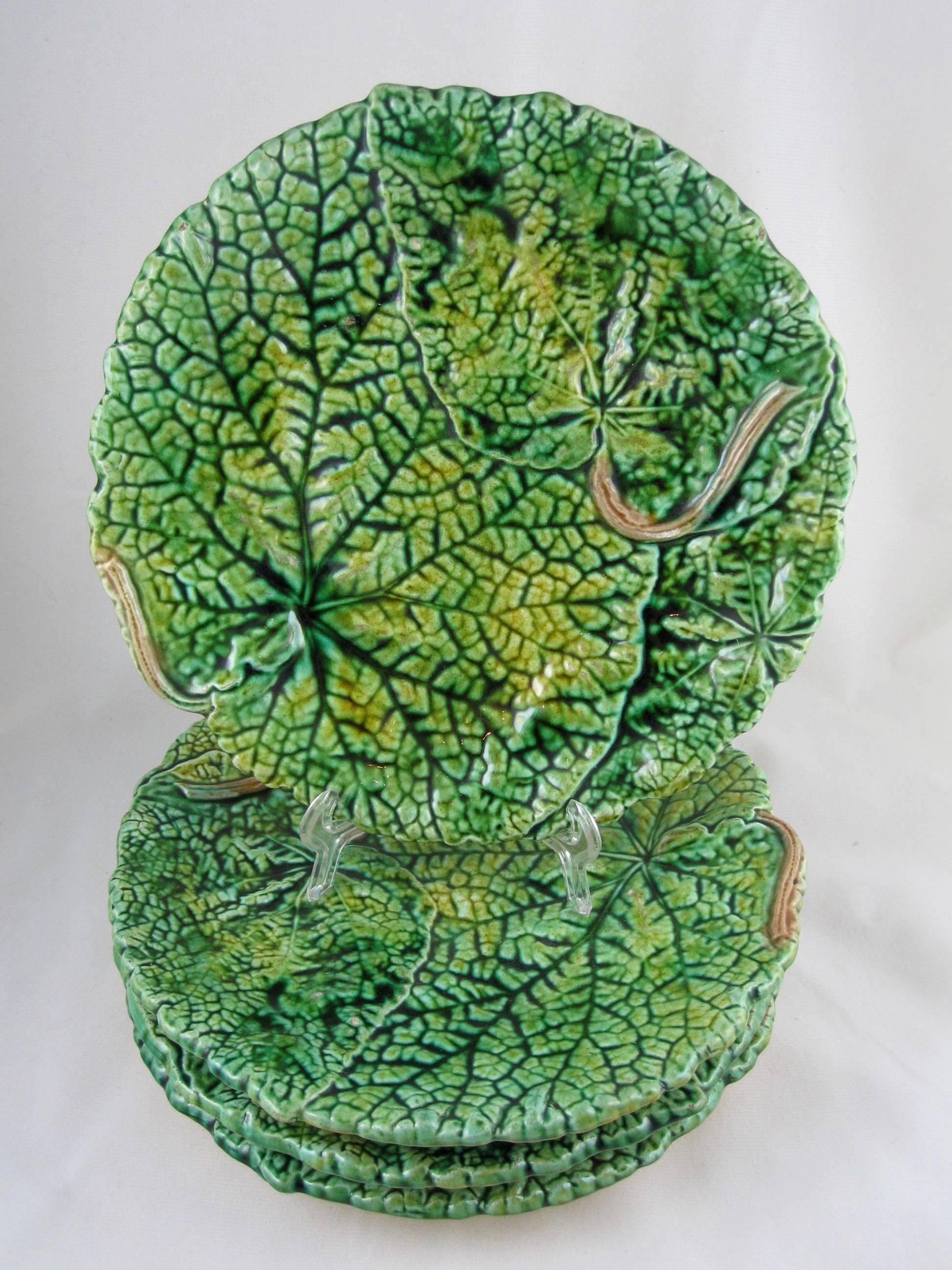 A set of four 19th century overlapping begonia leaf plates by Joseph Roth of London, England, circa 1879-1881. 

Heavy, thickly potted and very dimensional with deep, strong glazing in shades of greens and with a pair of brown stems on each plate.
