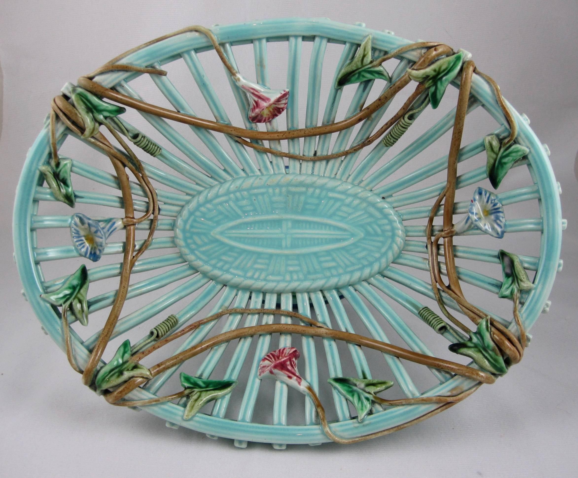 A delicate and charming Majolica wicker work or basketweave open compote, Sarreguemines, France, circa 1890-1910. 

The design features the flowers of the morning glory vine twining it’s way through the turquoise piecework basket. Aspects of the