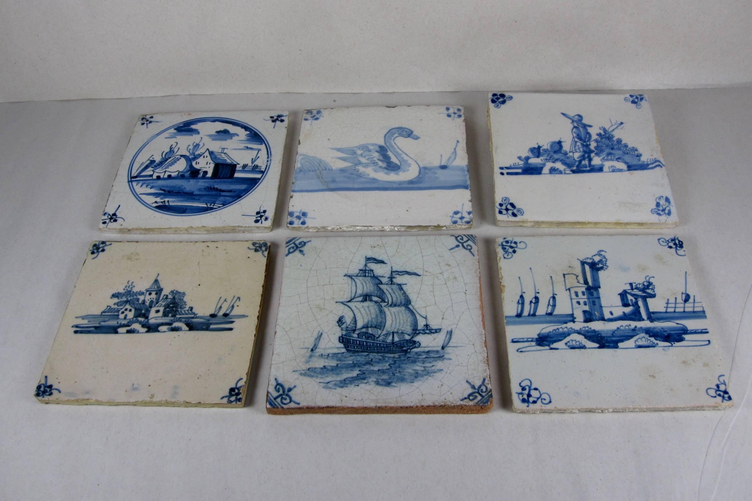 An assembled set of six, hand-painted, 18th century English delft blue tiles. English delftware is tin-glazed pottery, provincial and naïve, made in the British Isles between about 1550 and the late 18th century. The main centers of production were