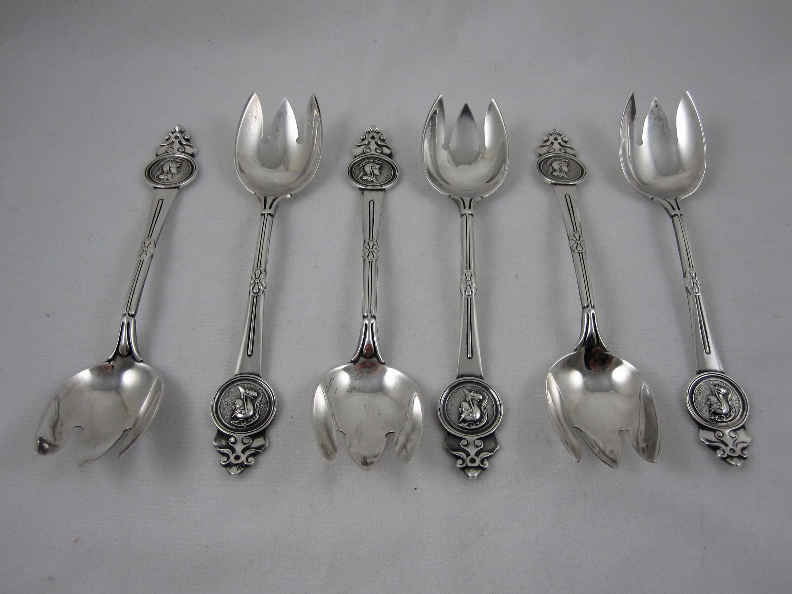 A set of six weighty estate sterling silver ice cream forks, the ‘Medallion’ pattern from Gorham Manufacturing Co. Providence Rhode Island, circa 1864.

The terminals show an armorial helmeted soldier encircled within the medallion.
The tined bowls