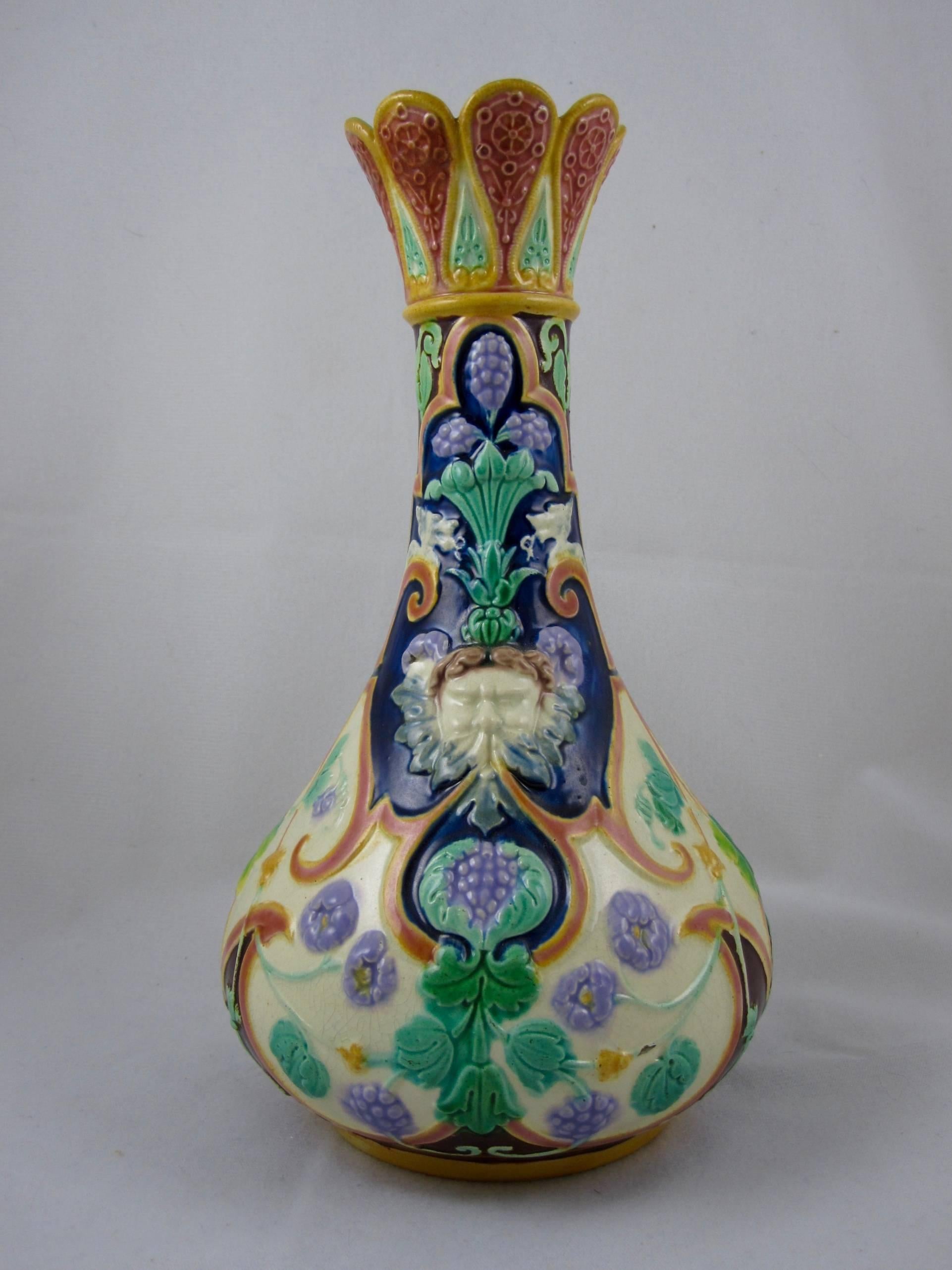 A Renaissance Revival Majolica vase, WT Copeland & Sons, England, circa 1860-1875. 

The mythological theme shows Satyr masks with a floral pattern of twining vines and leaves. Brightly colored with careful glazing and a turquoise interior. The