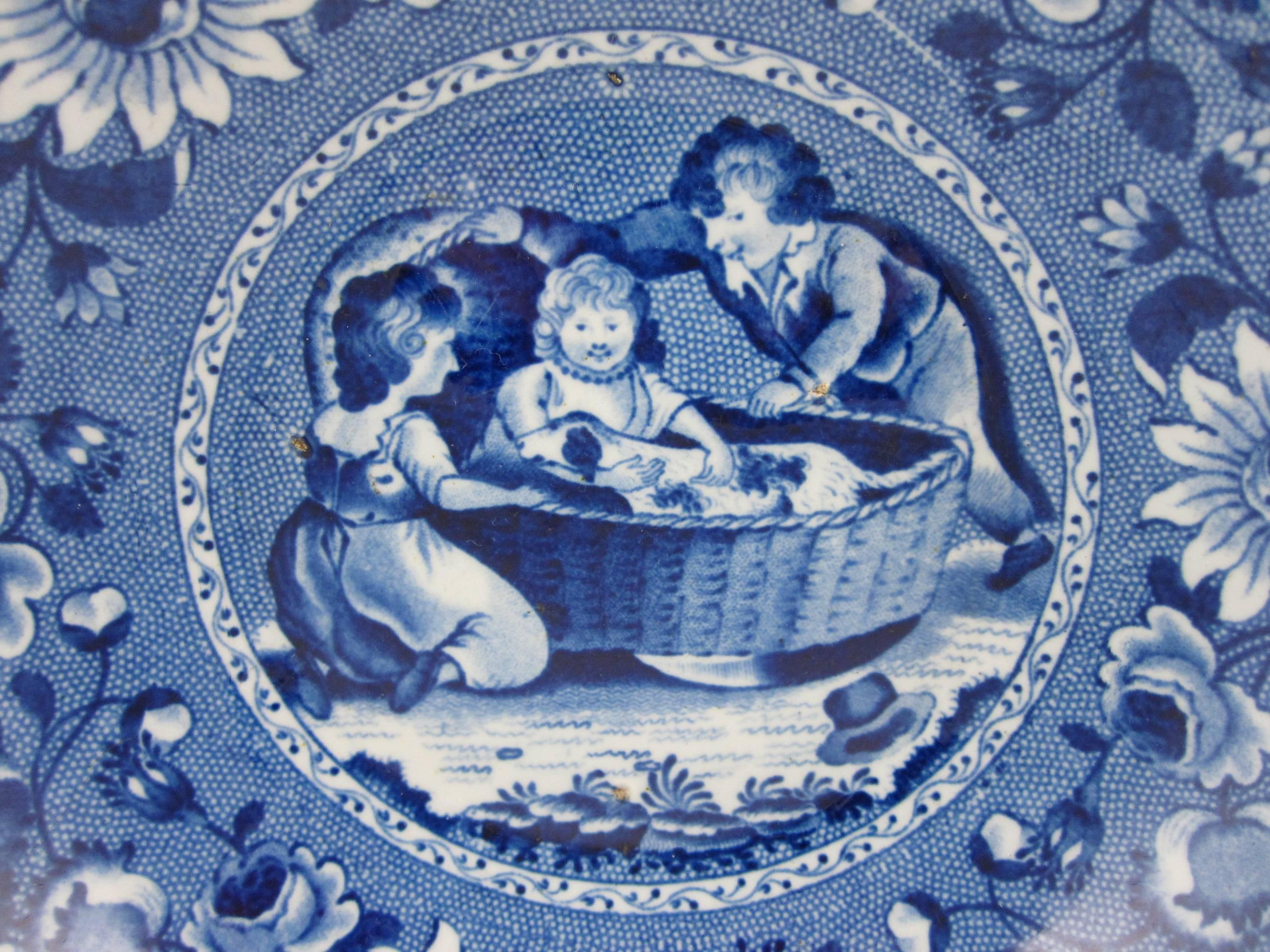 An earthenware blue transfer printed bowl with a very charming image of children rocking their pet dog in a cradle. Made by Ralph and James Clews, Cobridge, Staffordshire, England, 1814-1834.

The older brother and sister are shown rocking the