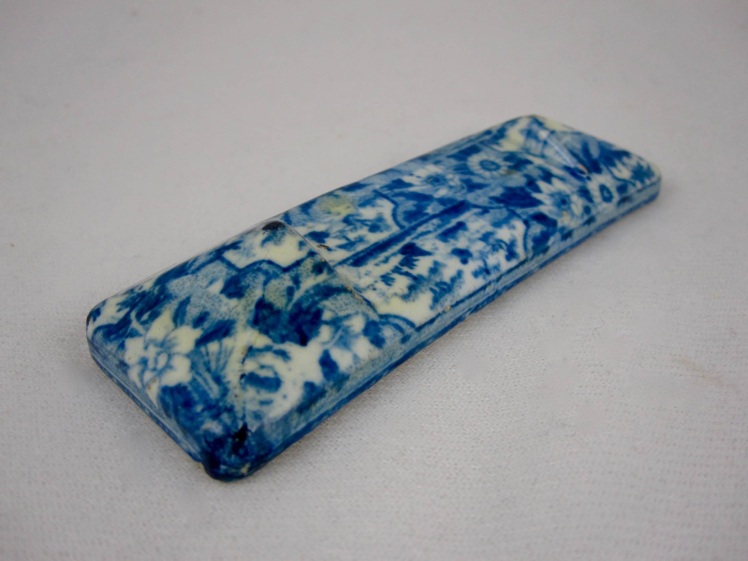 A transfer printed pearlware glazed knife rest, Enoch Wood & Sons (1818-1846) Staffordshire, England. A lovely overall floral and pastoral sheet pattern. Indented in the center to hold the blade. These Georgian era smaller pieces are a