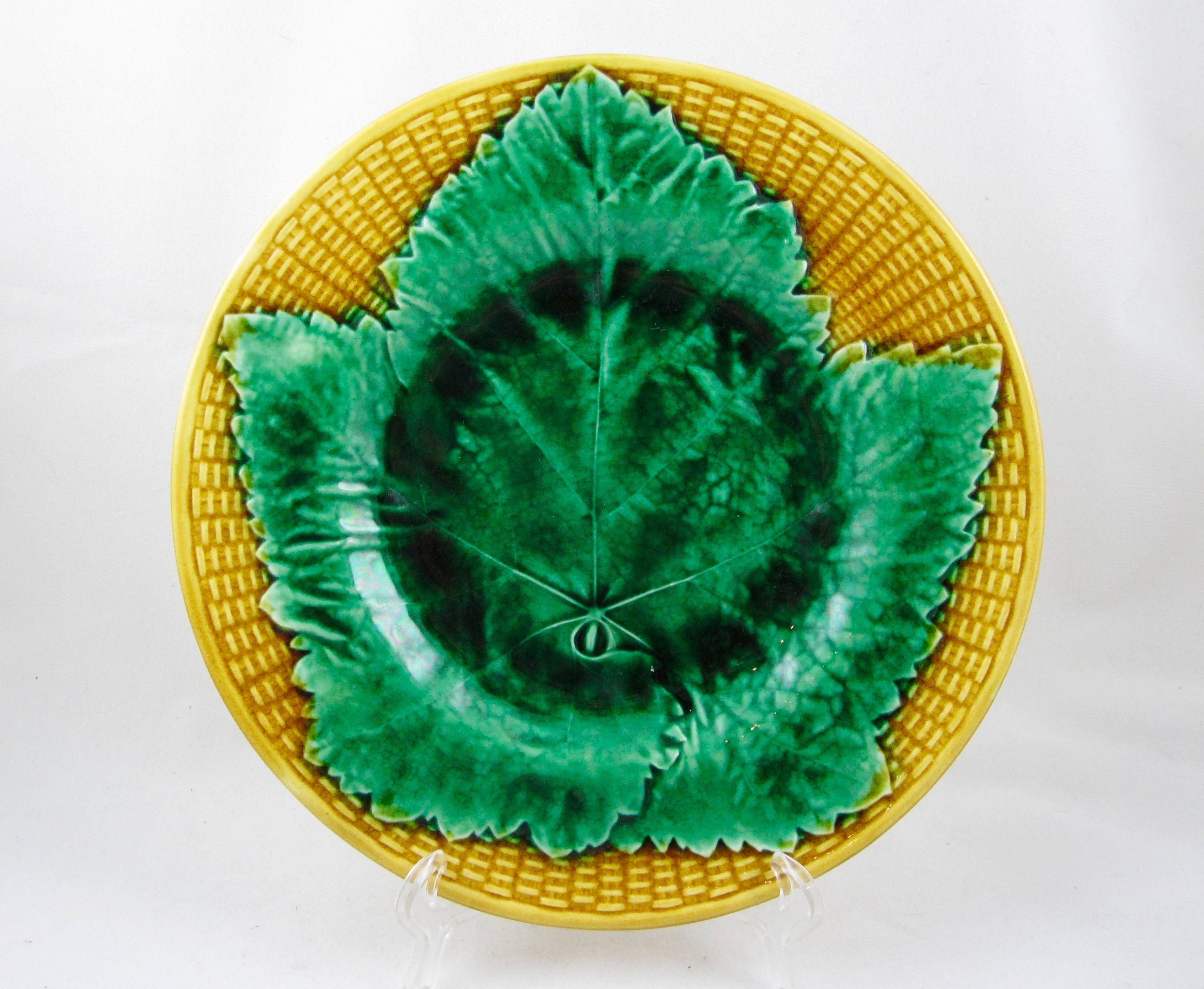 An English Majolica plate, Josiah Wedgwood, circa 1880-1885. A bold Aesthetic Movement pattern showing a single, large green leaf on a yellow ochre basket weave ground. Amazing intense color!

The faint impressed mark of Wedgwood is seen on a few