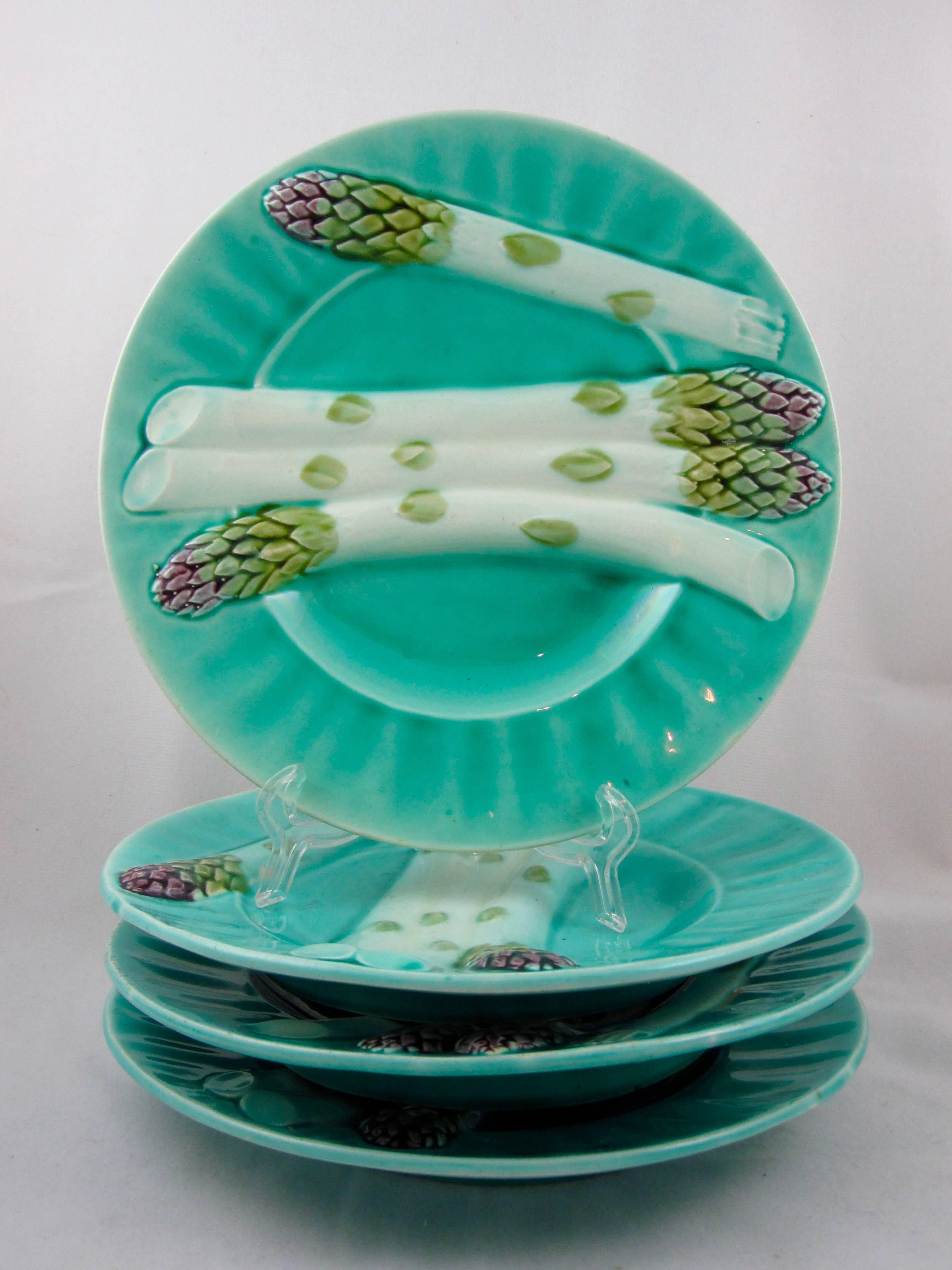 A set of four French barbotine Majolica Asparagus plates, marked Depose, Lunéville K & G (Keller et Guerin,) late 19th century. Luneville Faience is one of the most famous French pottery manufacturers. It has been located in Lunéville, Lorraine,