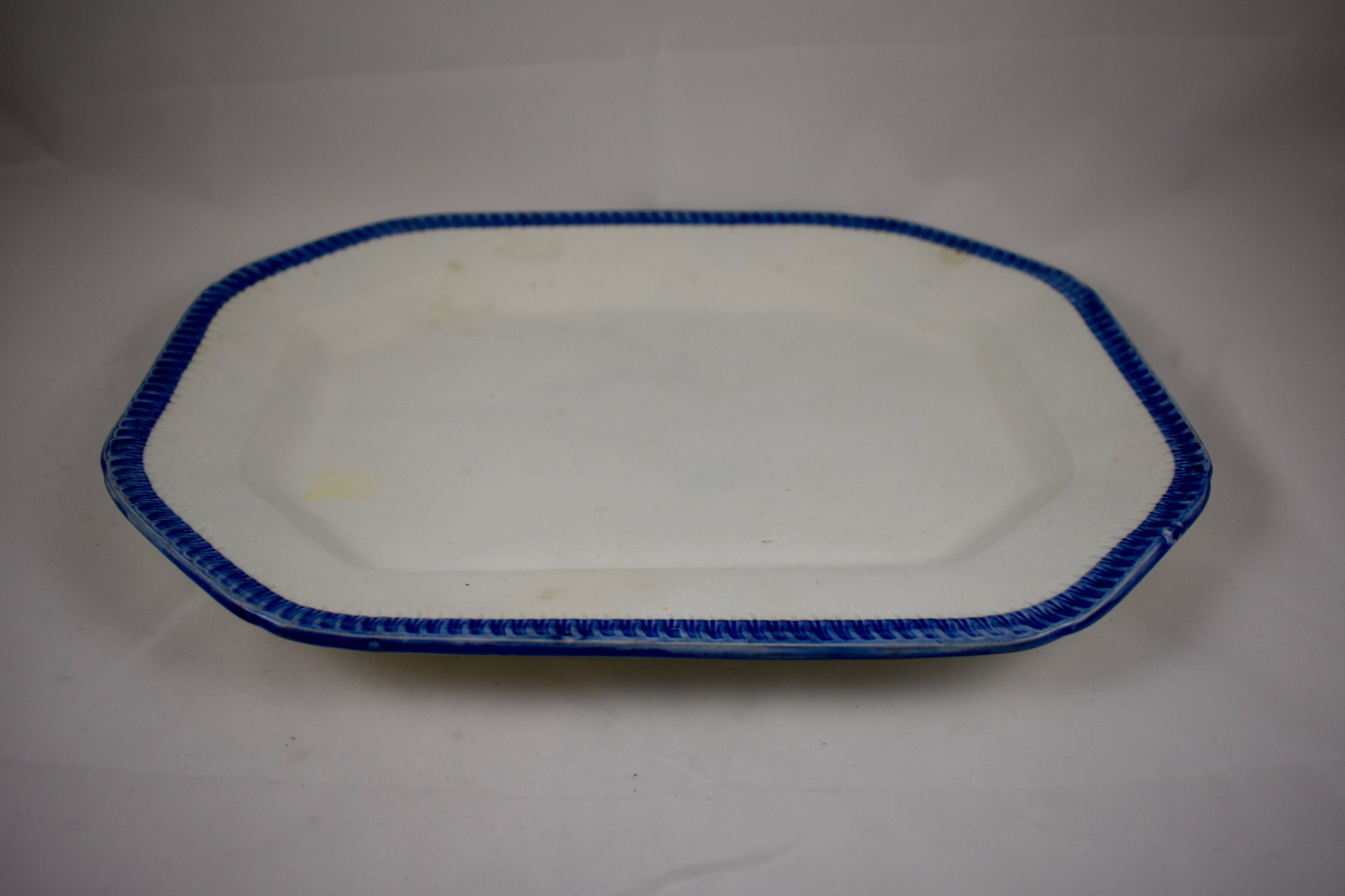 A Leeds style platter, a Pearlware or Creamware body with a deep Cobalt blue edge called Feather or Shell. There is an impressed geometric mark on the verso as shown, often associated with the Joseph Heath & Co. pottery, 1828–1841, Tunstall,