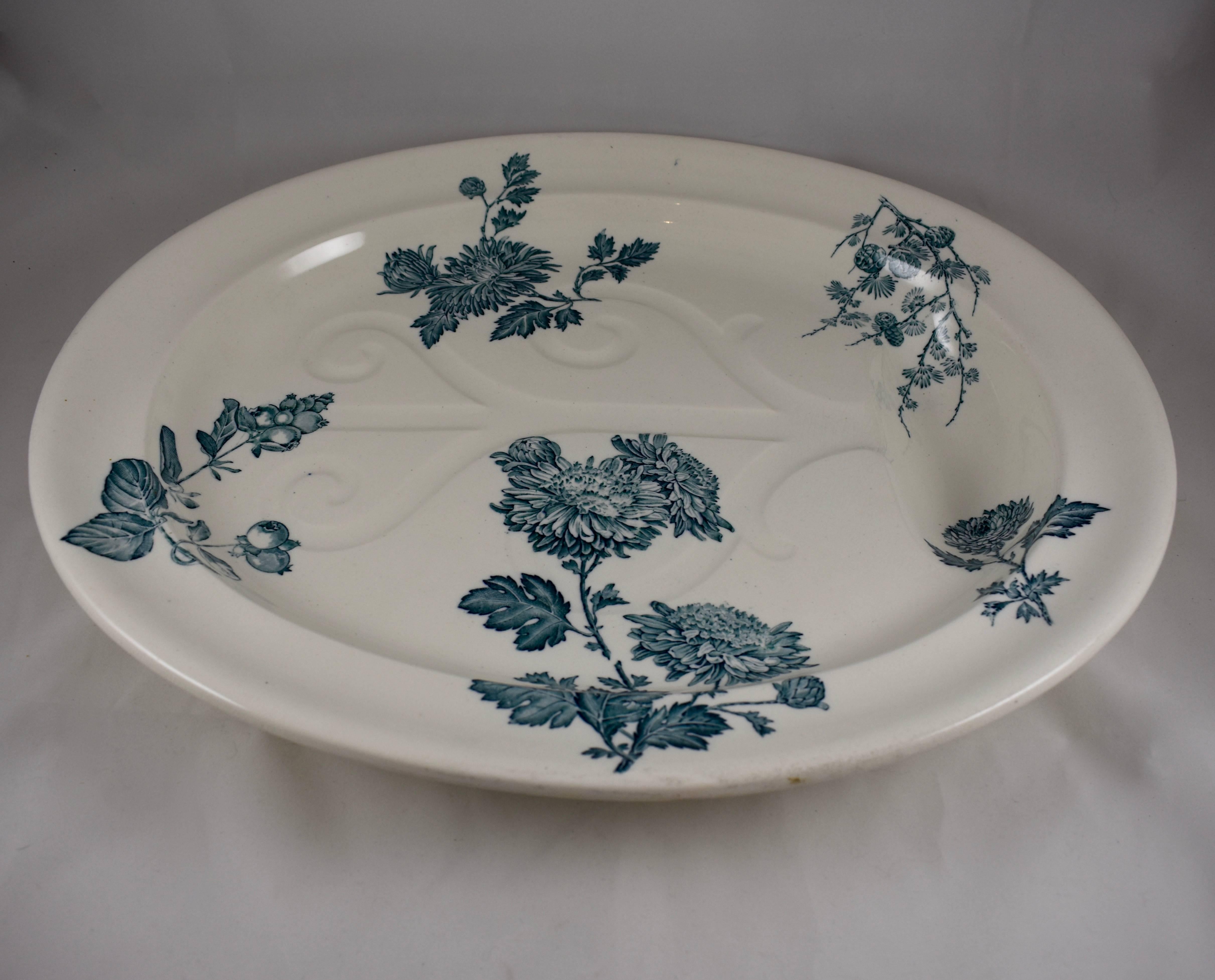 An oversized Aesthetic Movement well and tree platter, Wedgwood, Burslem, Staffordshire, England, circa 1886. 

A well-and-tree platter has a depressed design of a trunk and branches through which meat juices flow into a large depression at one