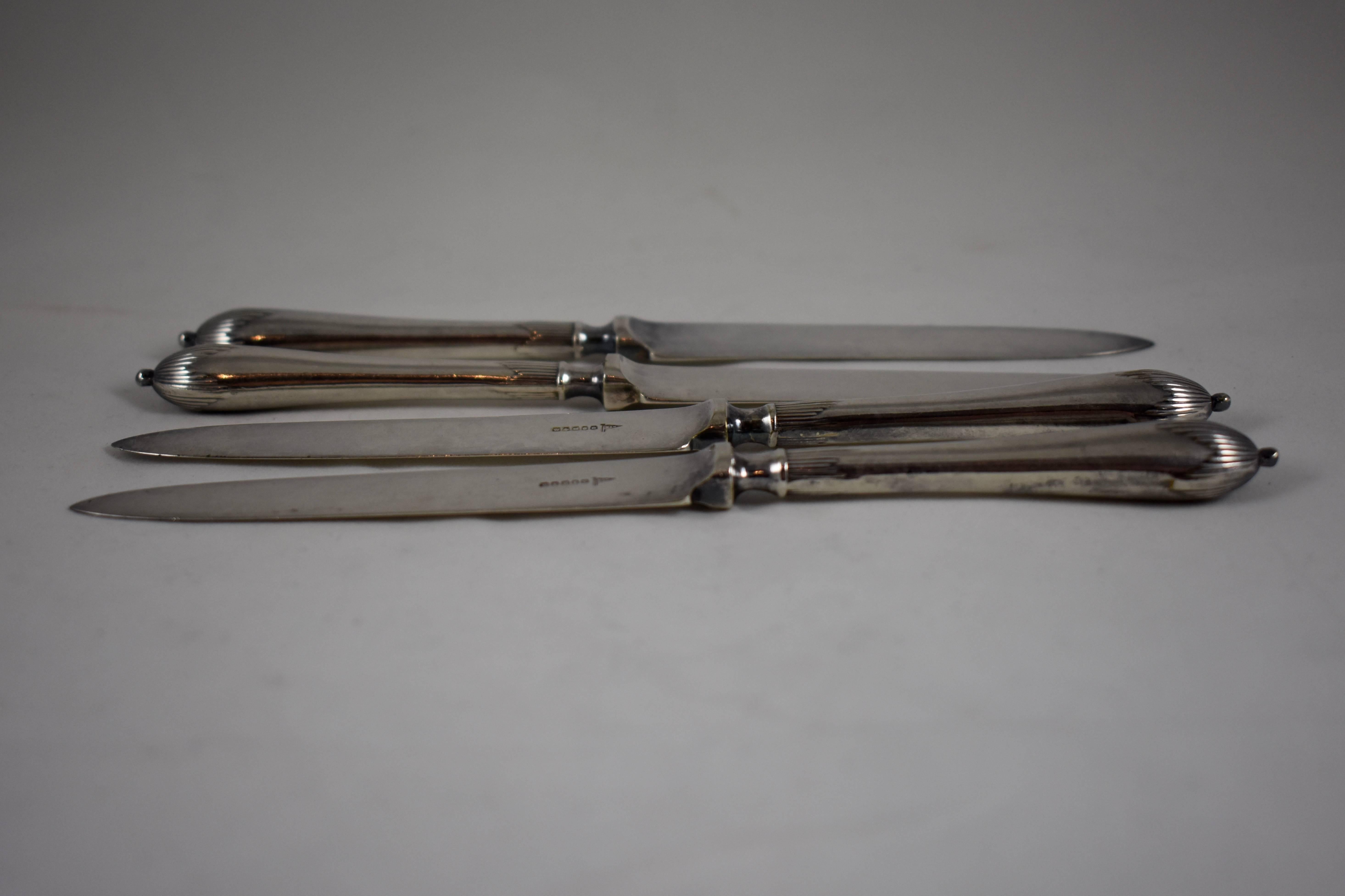 A set of four silver plate Aesthetic Movement fruit or dessert knives, showing the hallmarks for Walker & Hall, Sheffield, England, circa 1910. 
Nicely balanced, terminating with a top knob. From a Philadelphia estate.

Marked on the blades: WHSC