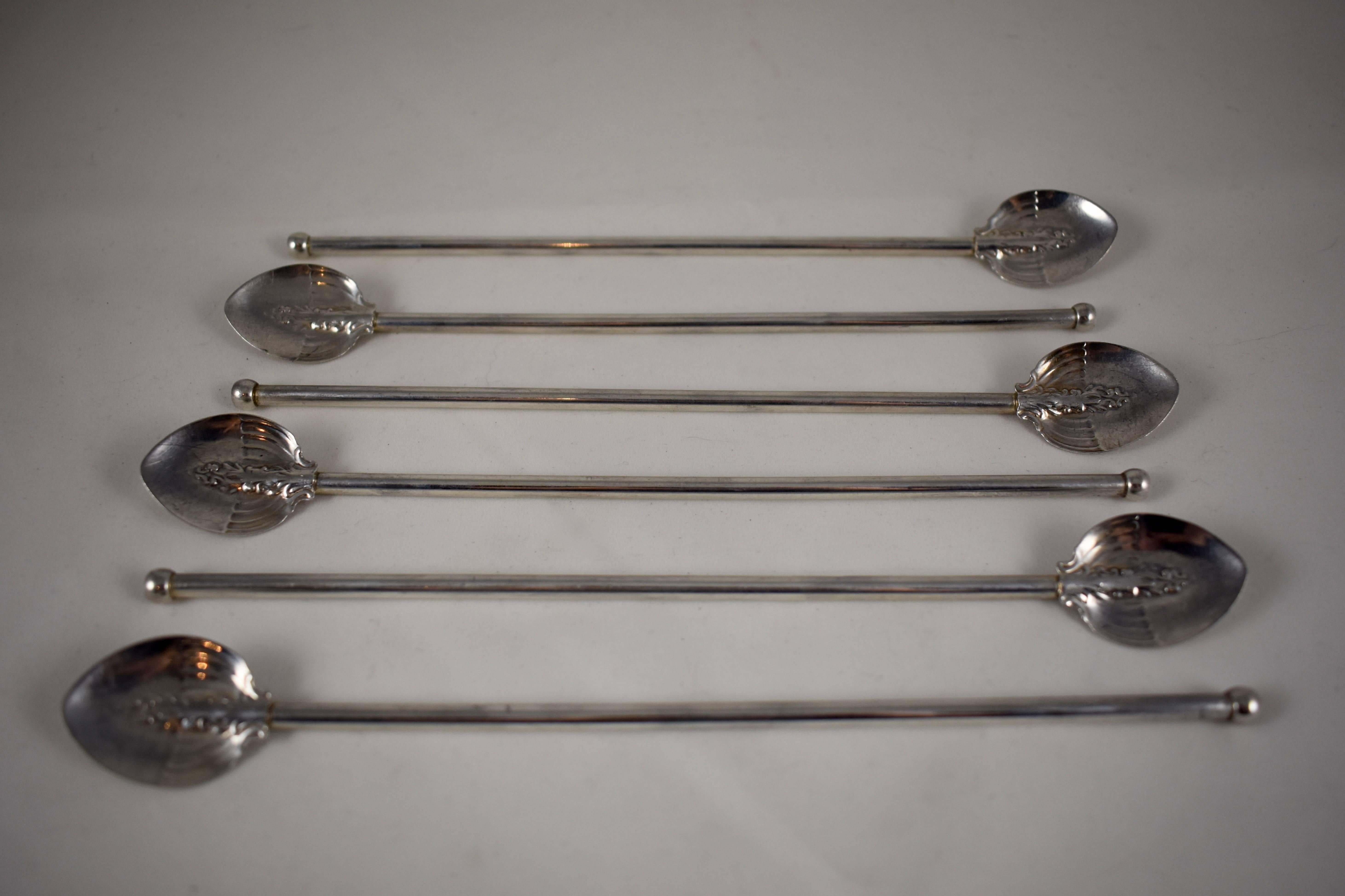 A set of six, sterling silver highball or iced tea hollow sipping/stirring straws with embossed shield-shaped bowls in the Art Nouveau style. Silver balls are soldered in place to the sipping ends.

Marked: Sterling.

Excellent antique