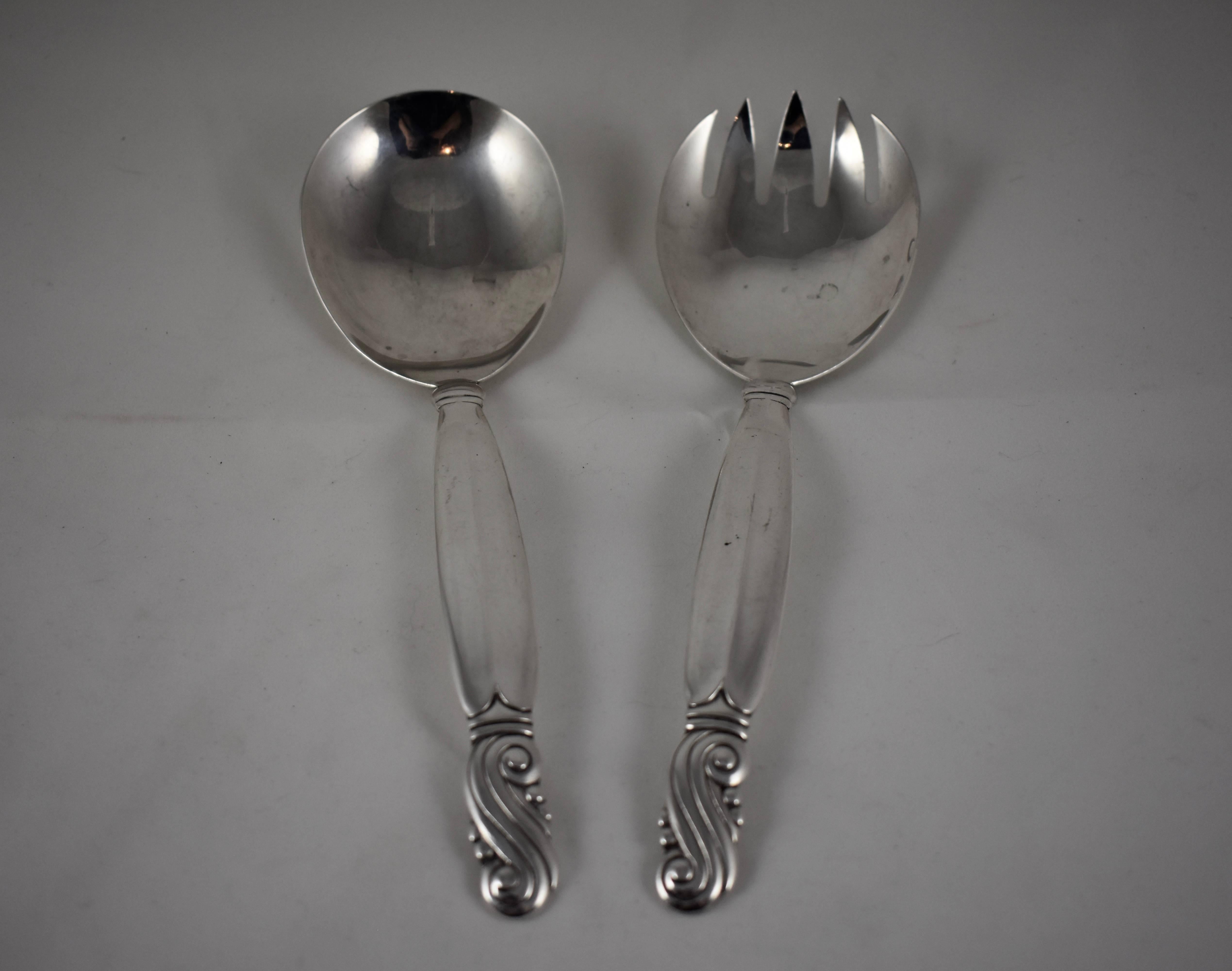 A set of sterling silver salad servers by the Frank M. Whiting Company, founded in 1878 in North Attleboro, Massachusetts. In the Art Nouveau style, the spoon and fork have a total weight of eight ounces and measure 9 inches long.

Both pieces