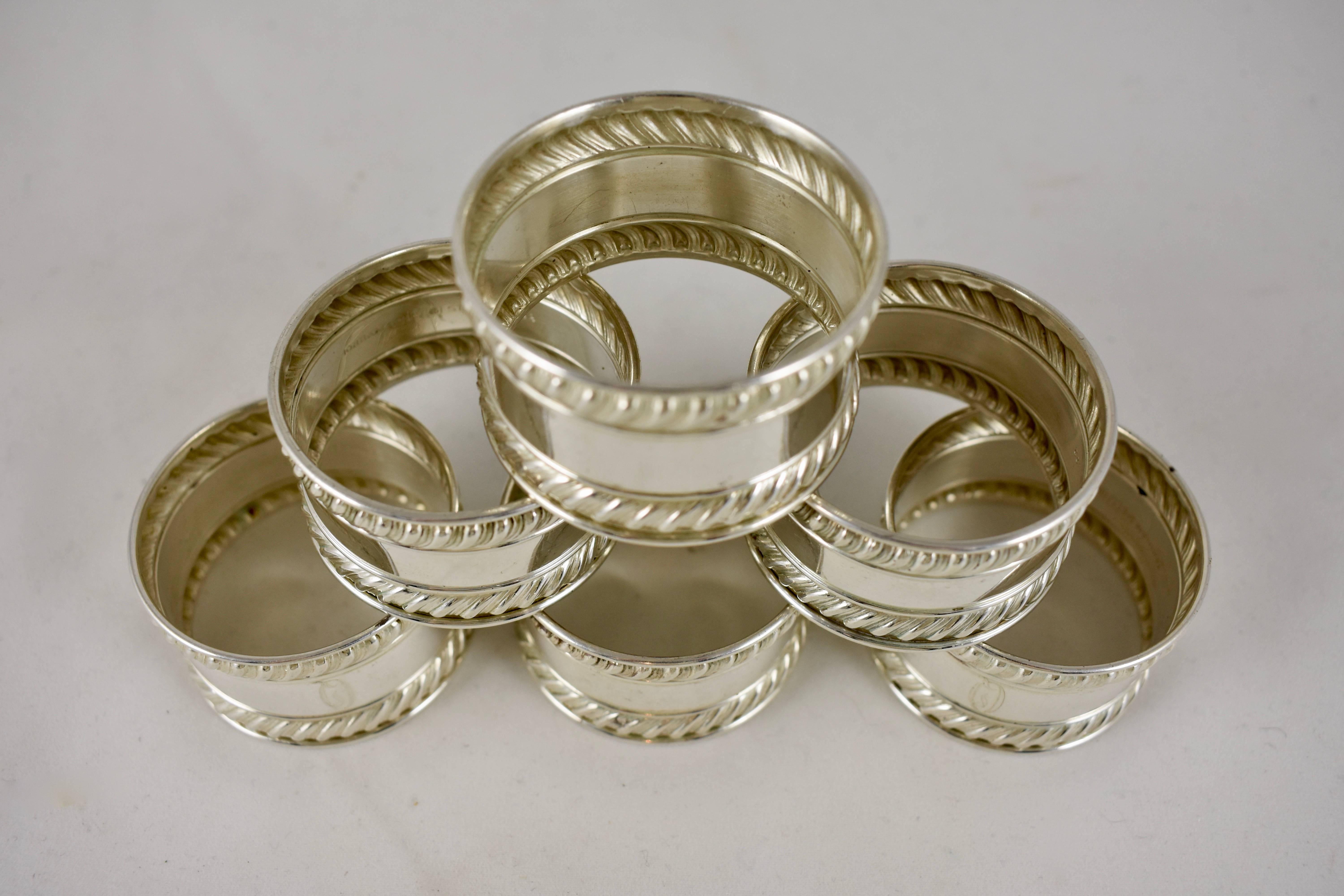A set of six estate sterling silver napkin rings, Gorham pattern number 522. A gadroon or rope edging, marked with the three sterling stamps used by Gorham in the early 20th century.

Faintly engraved with the letter, ‘Q’
 8 ounces, total